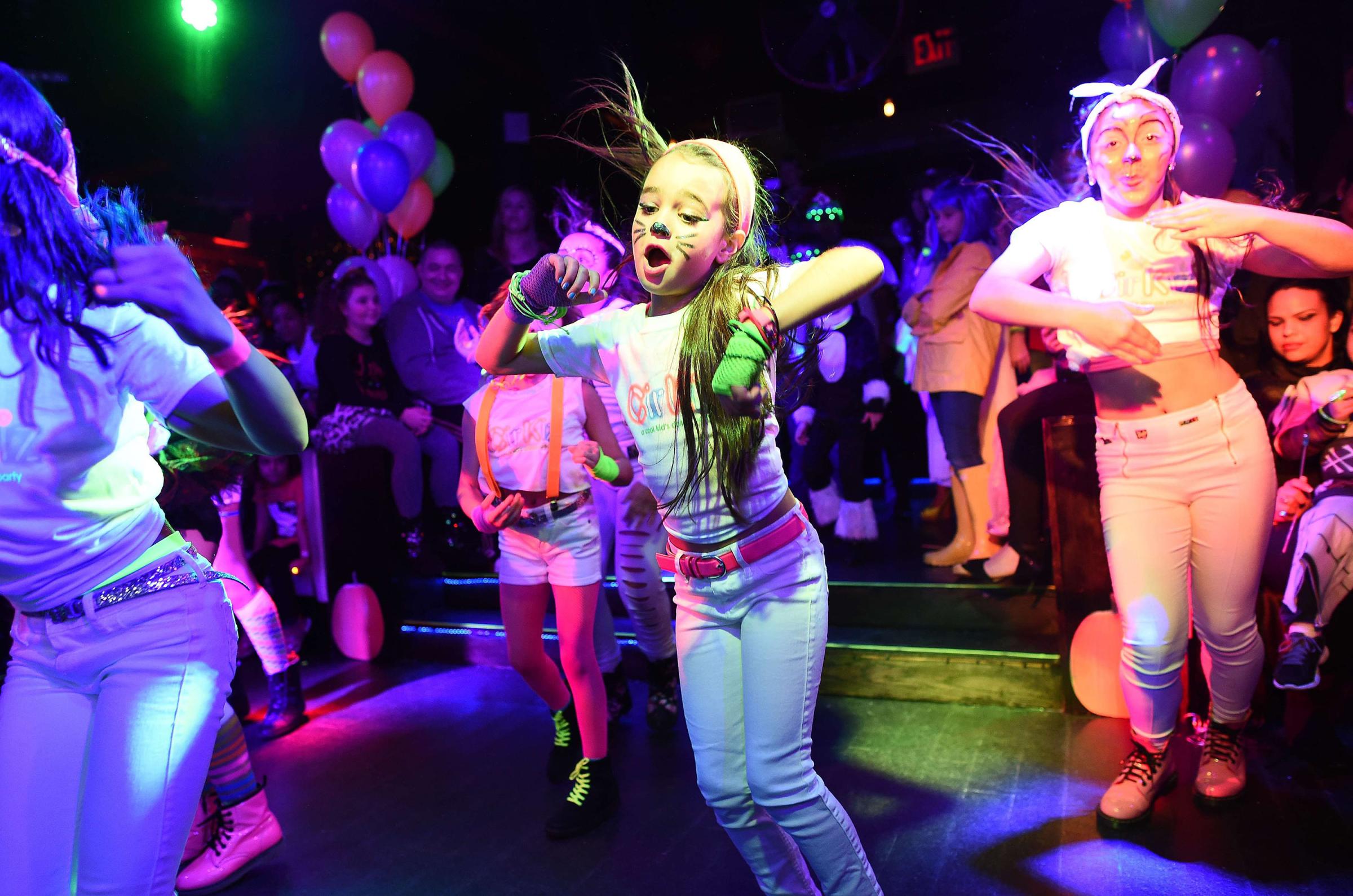 Kids wearing Halloween costumes dance during an electronic dance music party organized by CirKiz at a night club in New York on Oct. 26, 2014.