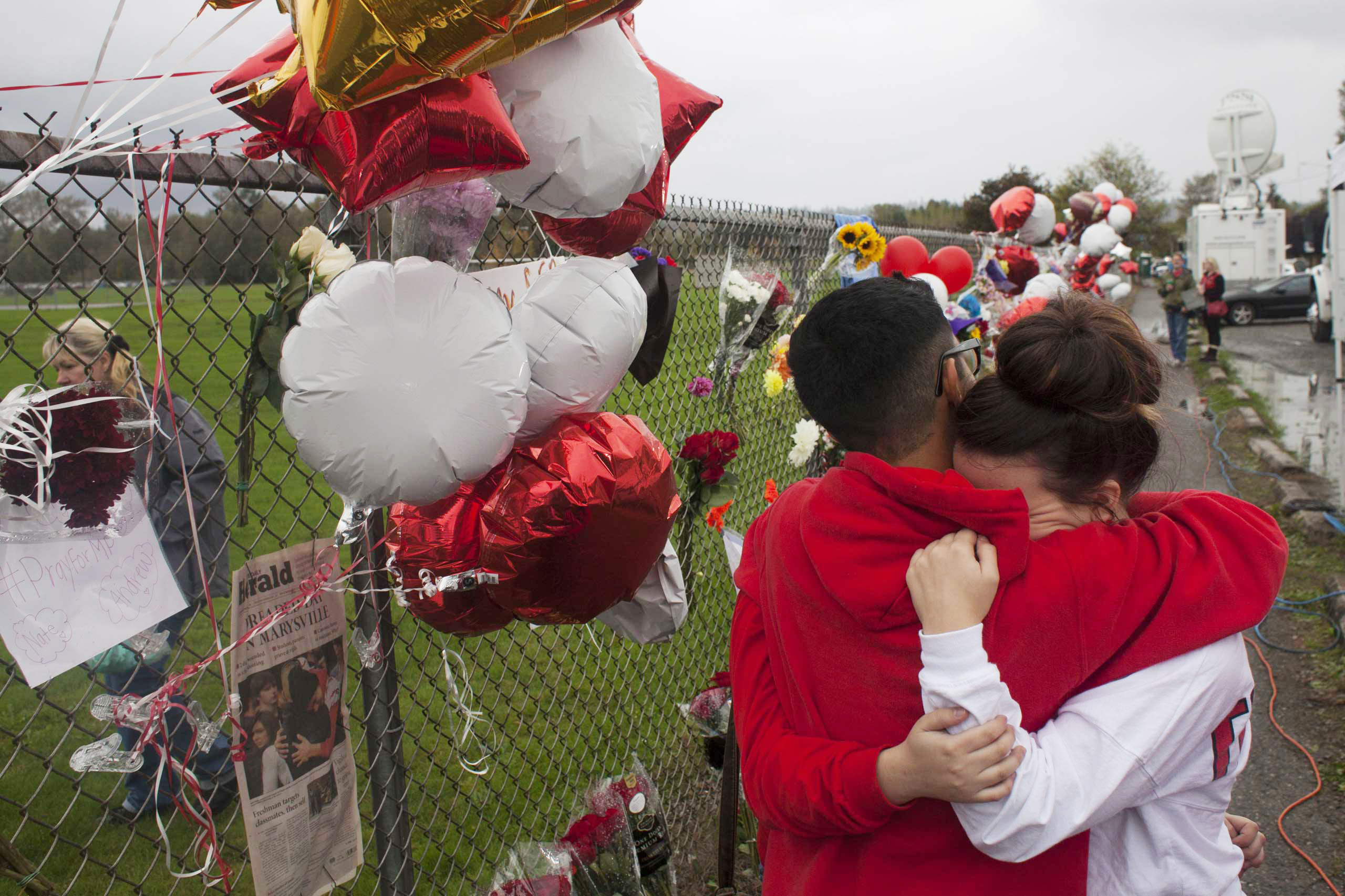 Students grieve beside a makeshift memorial at Marysville-Pilchuck High School in Marysville, Wash. (David Ryder—Getty Images)