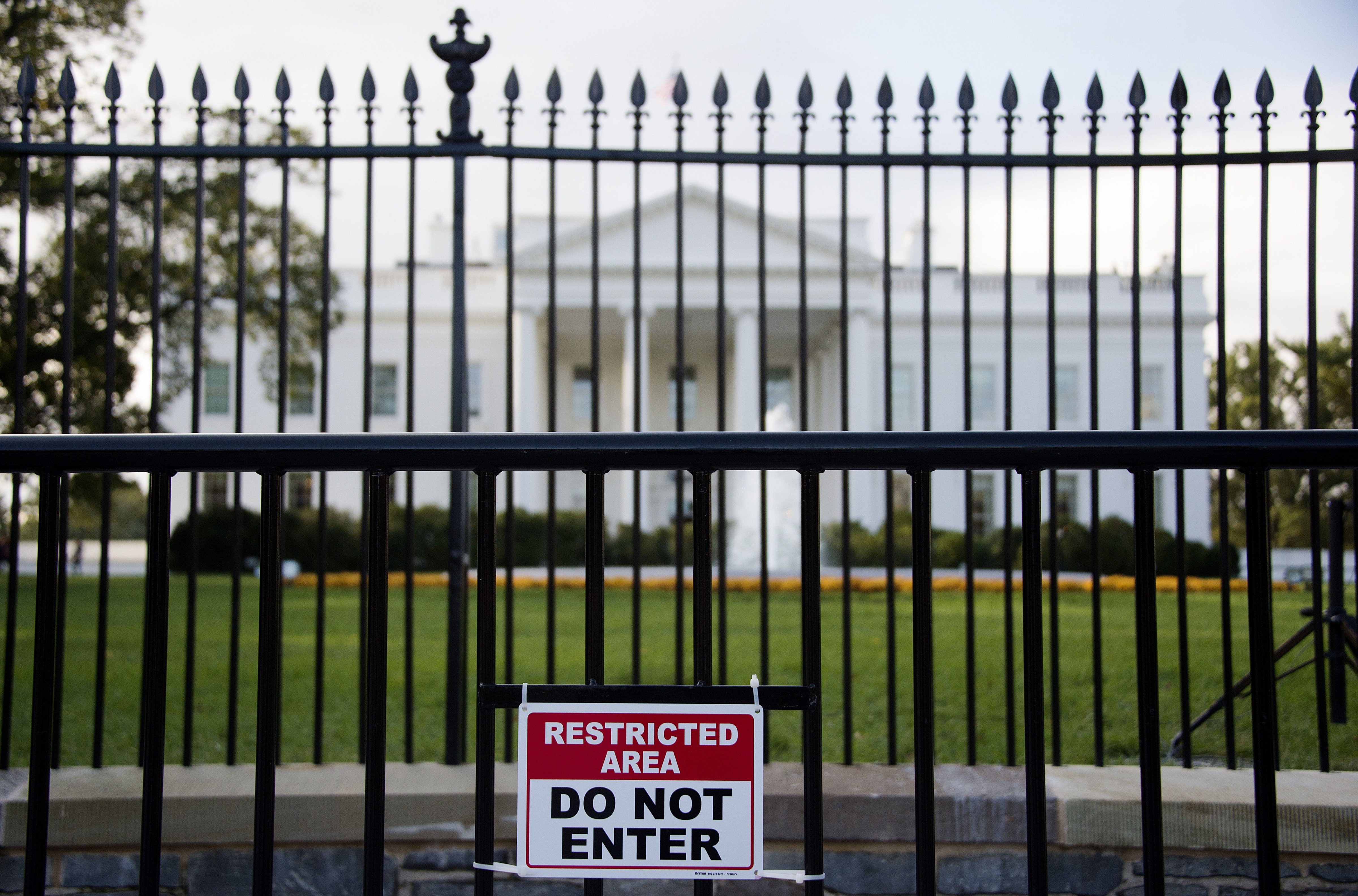 A sign warning of a restricted area is posted on the temporary barricade in front of the fence line to the White House in Washington, DC, October 23, 2014. (Jim Watson&mdash;AFP/Getty Images)