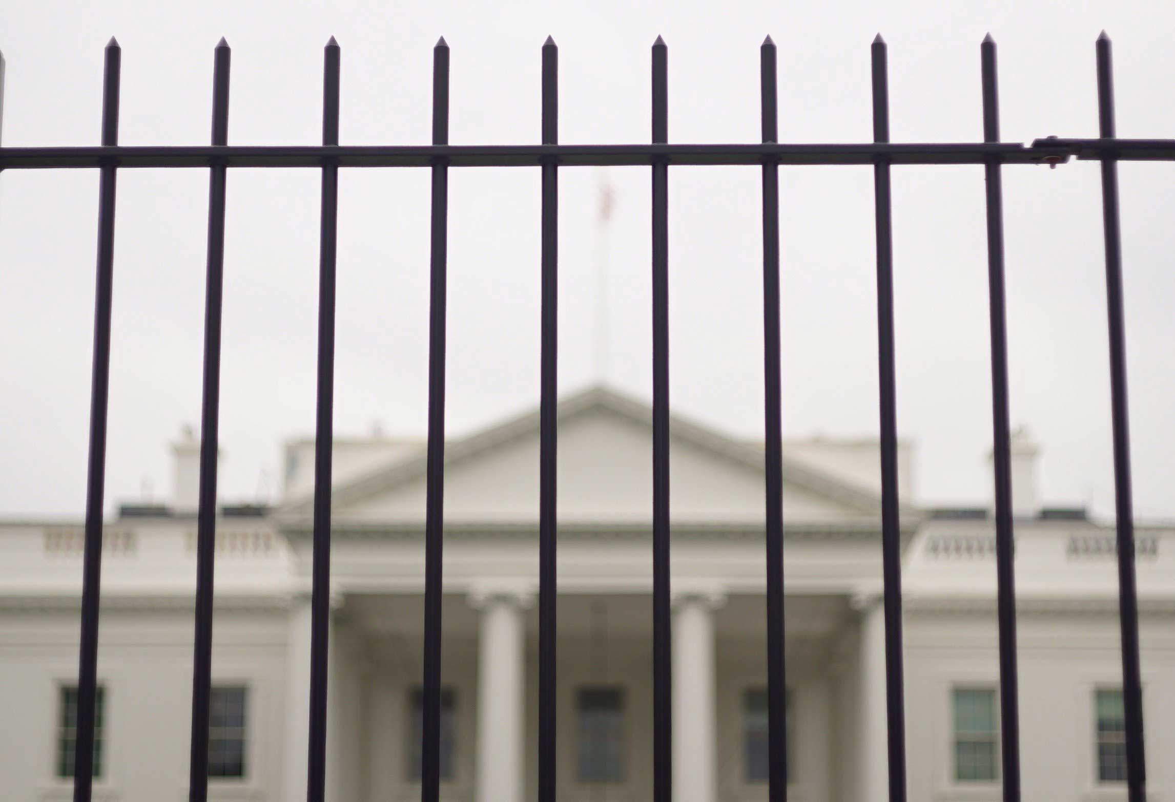The White House is seen behind a fence on Oct. 3, 2014 in Washington. (Mandel Ngan—AFP/Getty Images)