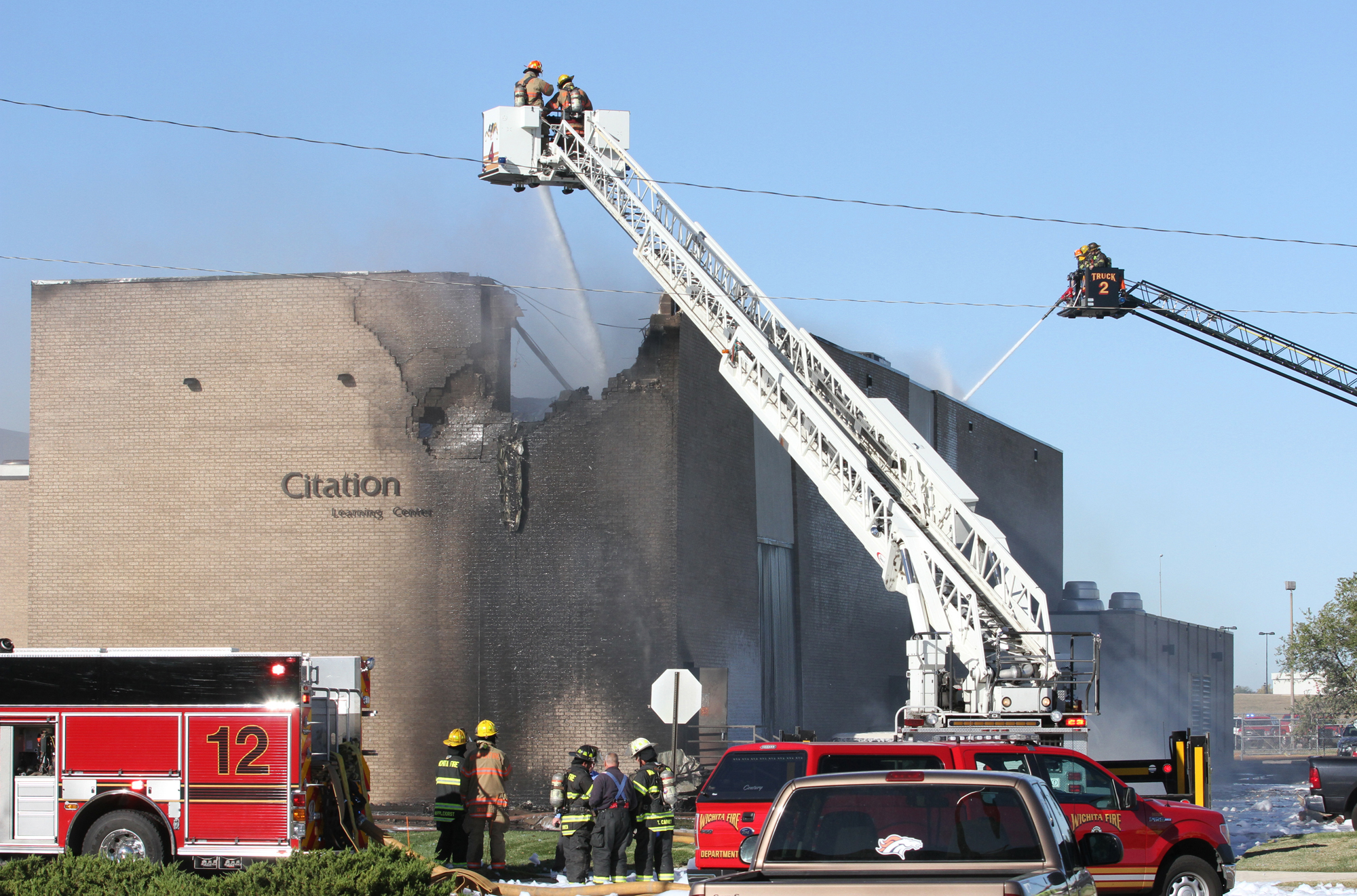 Firefighters try to put out a fire at Mid-Continent Airport in Wichita, Kan. on Oct. 30, 2014 shortly after a small plane crashed into the building killing several people including the pilot. (Brian Corn—AP)
