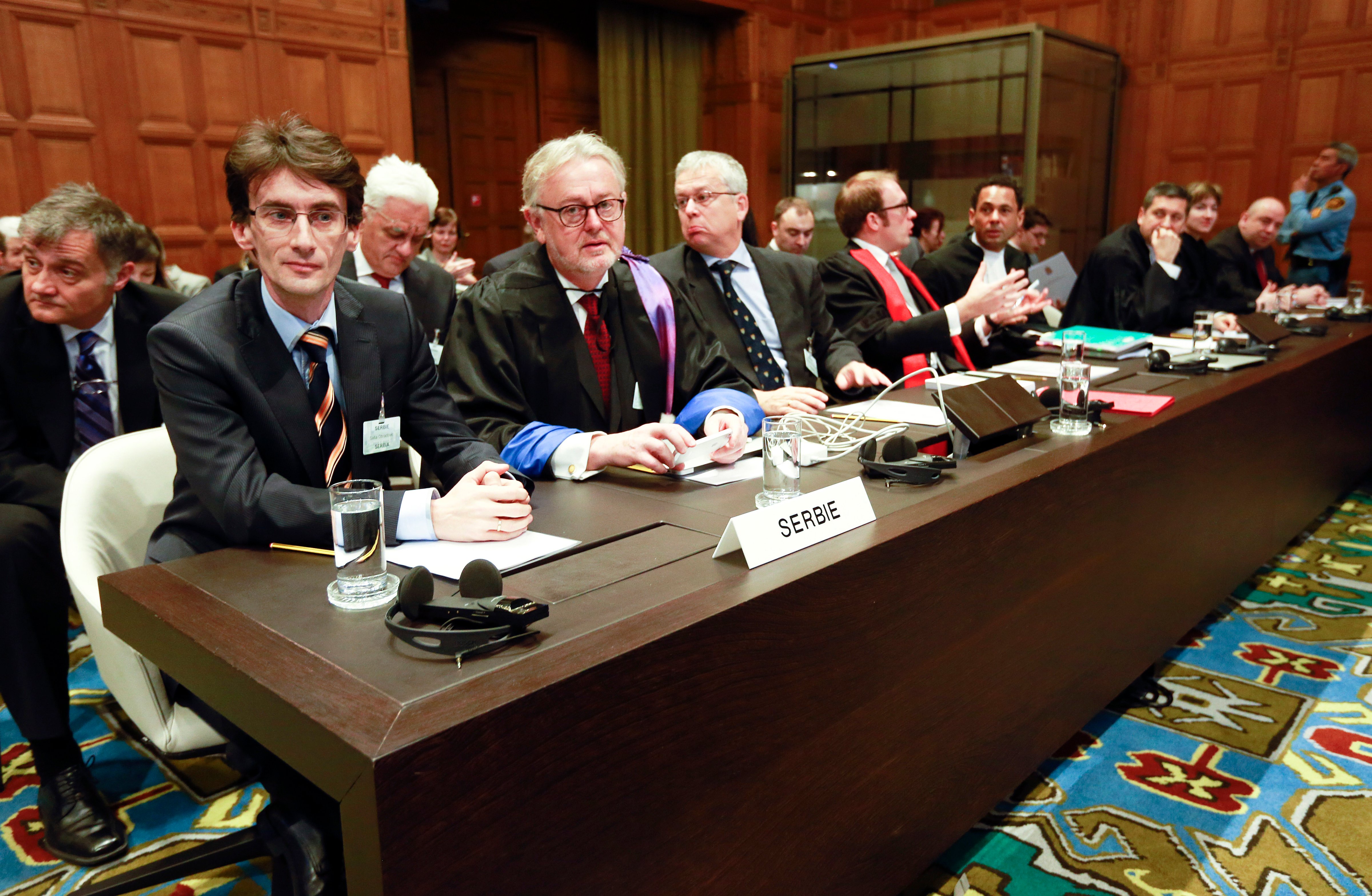 Members of the Serbian delegation, from left: Sasa Orbadovic, William Schabas, Andreas Zimmermann, Christian Tams and Wayne Jordash await the start of public hearings at the International Court of Justice (ICJ) in The Hague,  Netherlands, Monday, March 3, 2014. (Jiri Buller&mdash;AP)