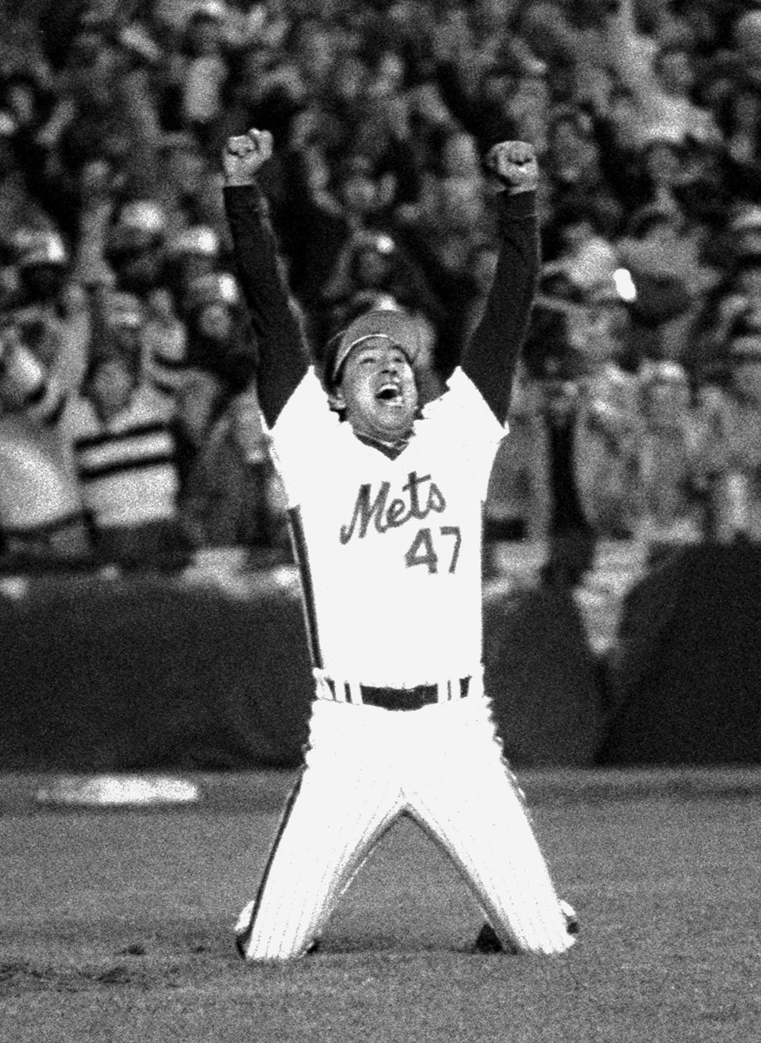 New York Mets' reliever Jesse Orosco and thousands of Met fans lift arms in jubilation as Marty Barrett, last Boston Red Sox hitter, bites dust at Shea Stadium. The Mets defeated the Red Sox, 8-5, in Game Seven of the 1986 World Series for championship on Oct. 28, 1986.