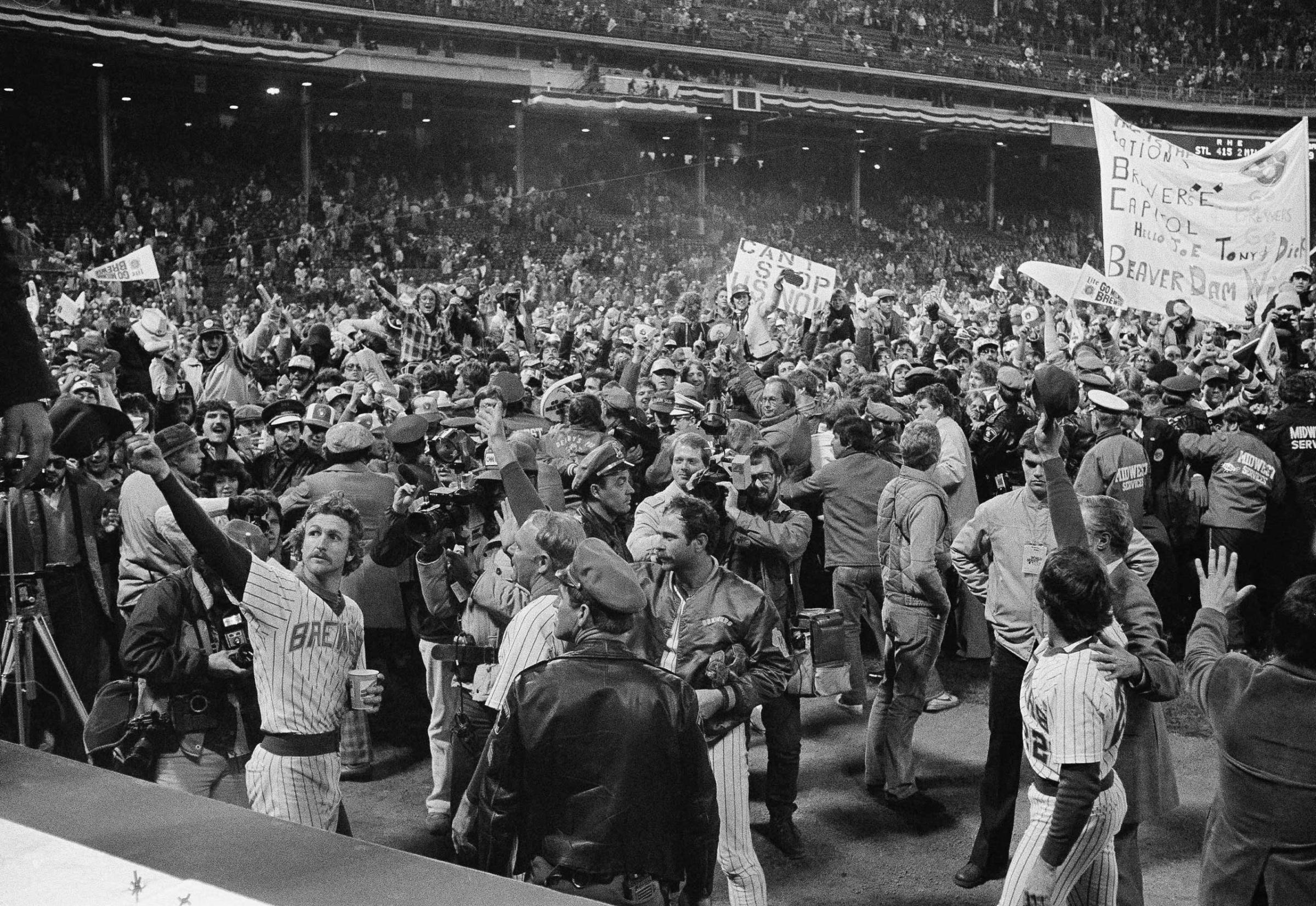 Milwaukee Brewers shortstop Robin Yount, left, waves to the crowd as they celebrate near the dugout in County Stadium after a World Series game, Sunday, Oct. 17, 1982, Milwaukee, Wi.