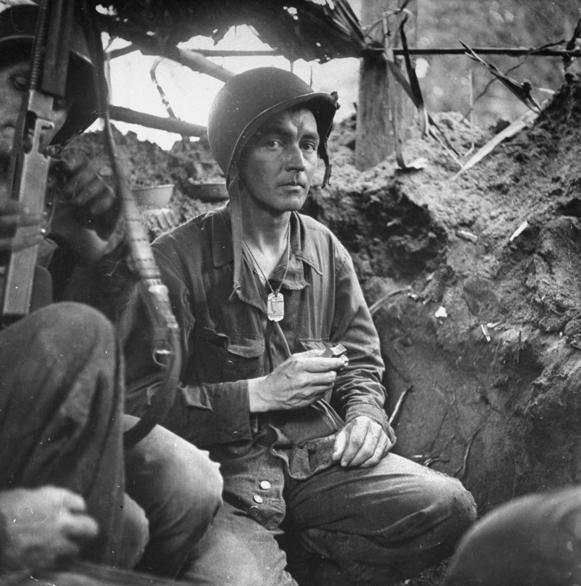 American Captain Byron E. Bradford in a trench during the fight against Japanese forces, Buna, New Guinea Campaign.