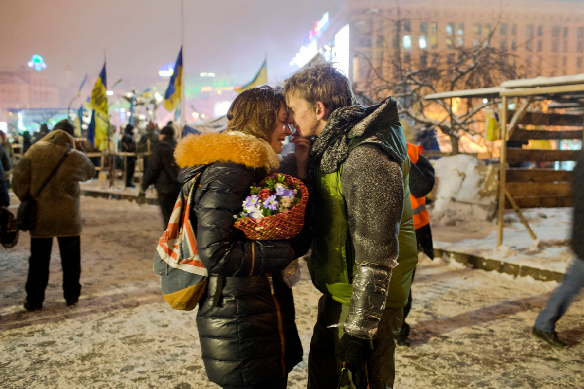 University students Sergey, 19, and Victoria, 20, a young couple from the eastern Ukrainian city of Dnipropetrovsk, embrace on Independence Square before Sergey heads off to Hrushevsky Street a short distance away where a street battle raged for a 4th day between demonstrators and police forces in central Kyiv. January 22, 2014