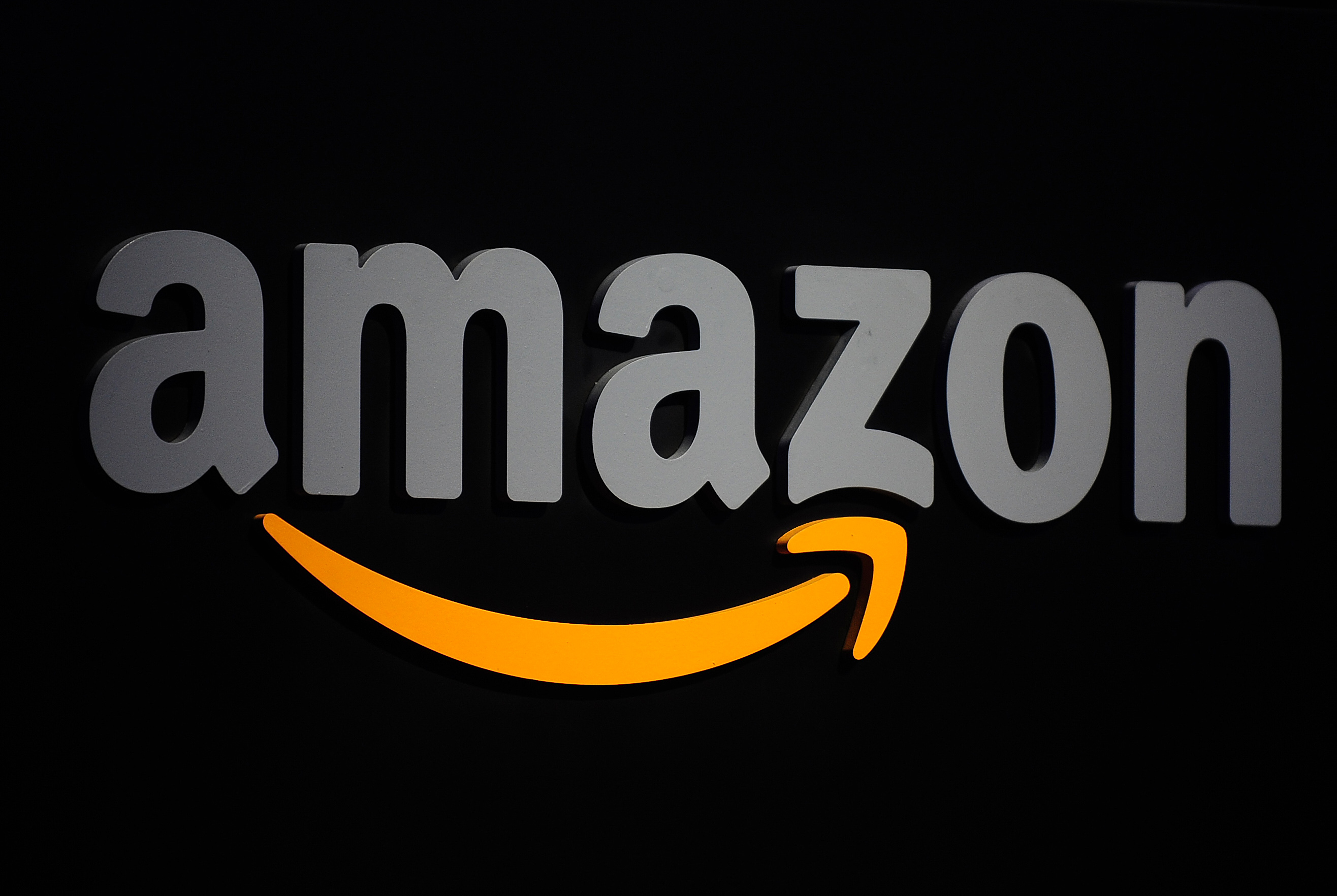 The Amazon logo is seen on a podium duri