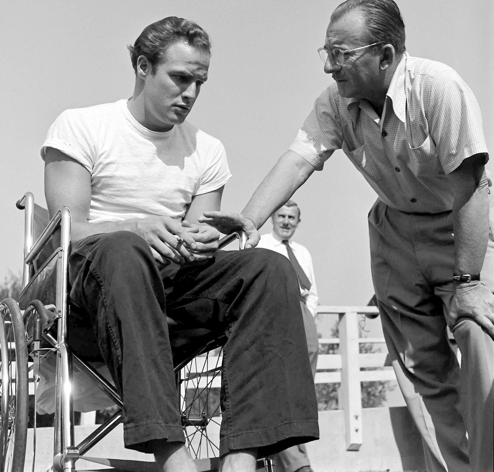 Marlon Brando chats with a production manager for 'The Men,' 1949.