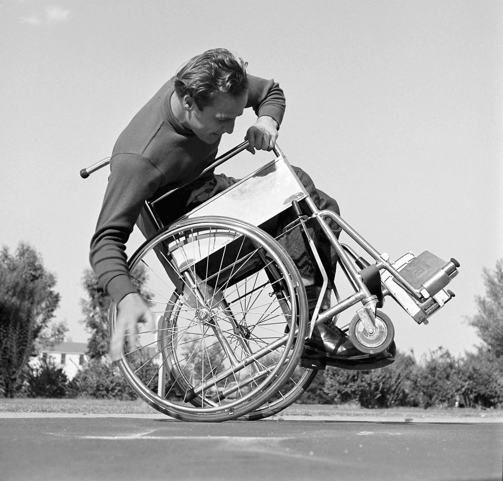 Marlon Brando attempts to tip and balance his wheelchair on the set of The Men, 1949.
