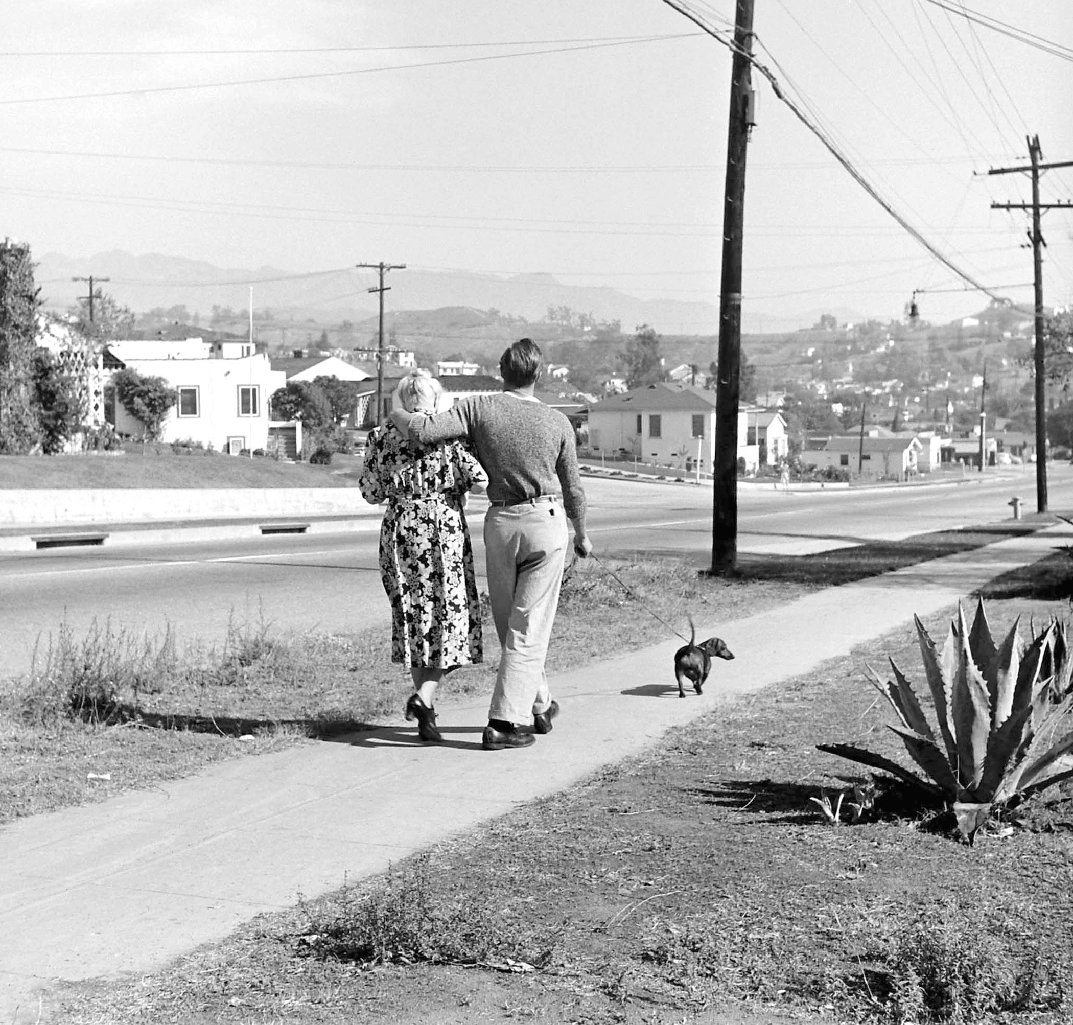 Marlon Brando goes for a stroll with his grandmother and her dog, 1949.