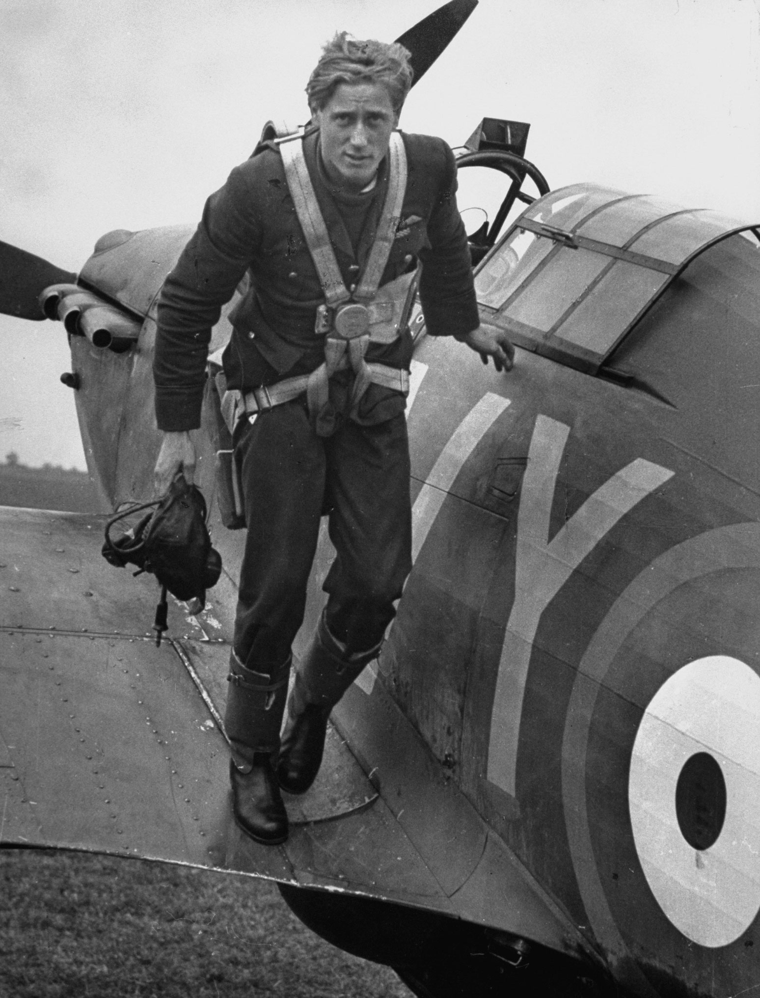 Royal Air Force ace Albert Gerald Lewis climbs out of his plane after an air battle above England, 1940.