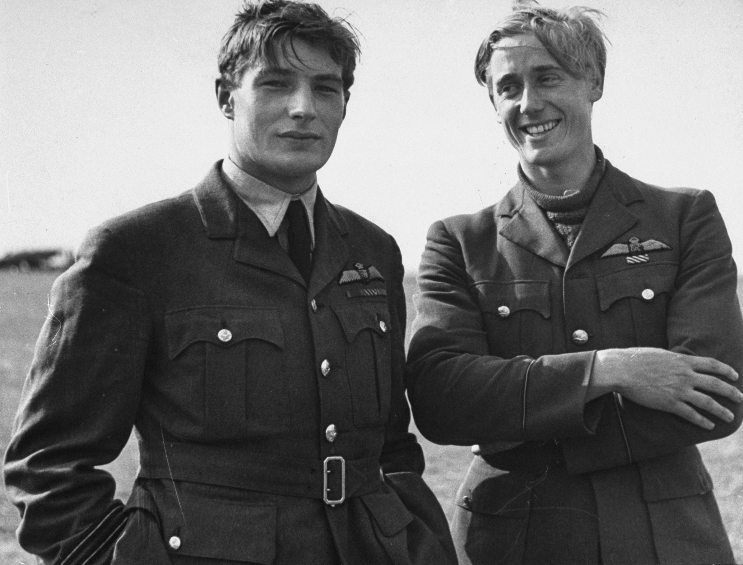 Two pilots (Flying Officer Albert Gerald Lewis on right, unidentified flyer at left) between flights during the Battle of Britain, RAF Fighter Command airfield, 1940.