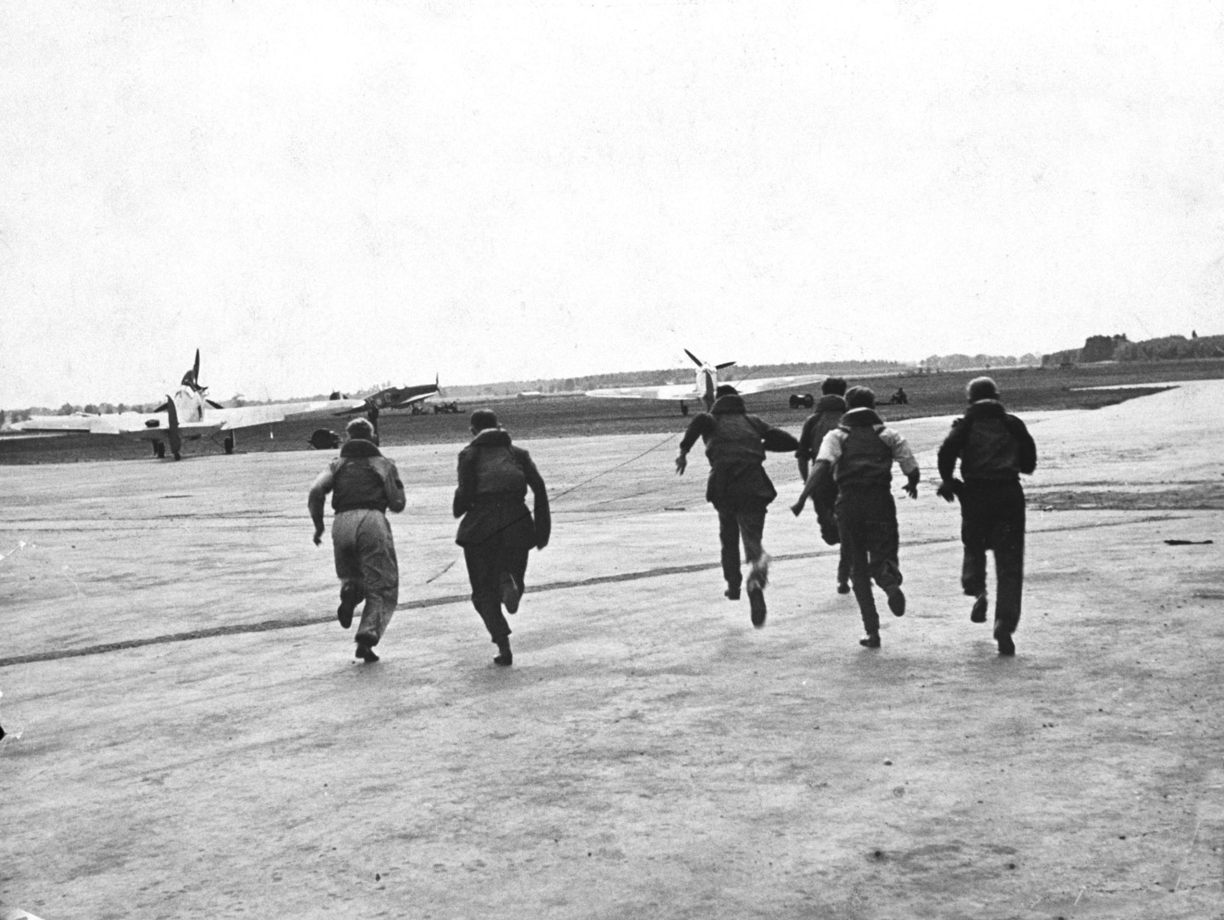 Pilots and aircrew members scramble to their planes during the Battle of Britain, RAF Fighter Command airfield, 1940.