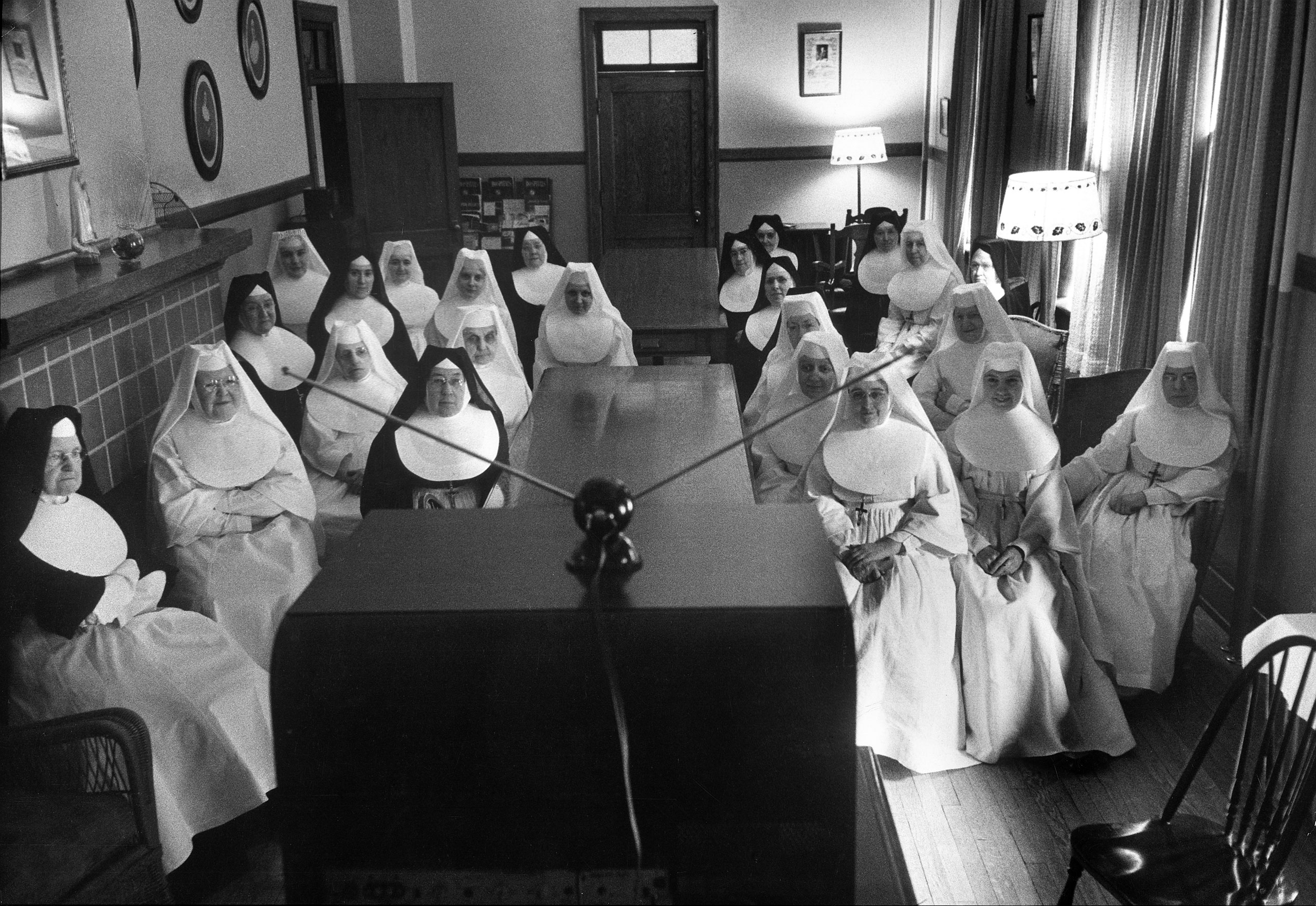 Sisters at St. Vincent's Hospital in Erie, Penn., watch a program on a new local TV station, 1949.