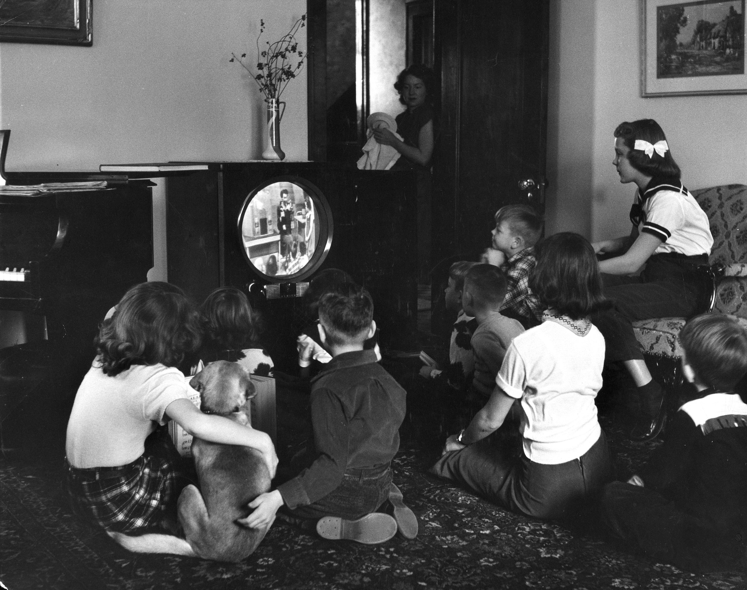 Grade school kids in Minneapolis watch a video  classroom lesson  on TV while the city's public schools are on strike in 1951.