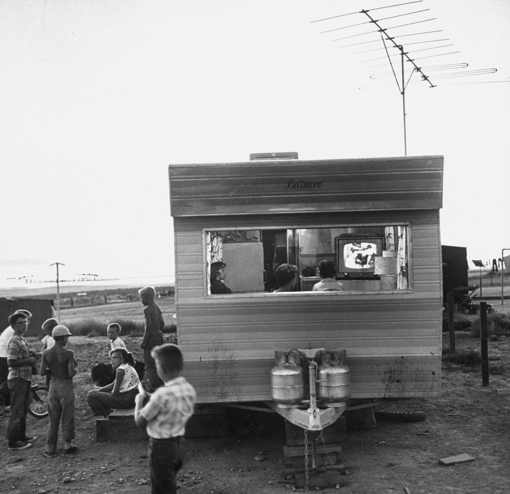 A railroad worker's family watches TV in a trailer at a camp for Southern Pacific employees in Utah in 1957.