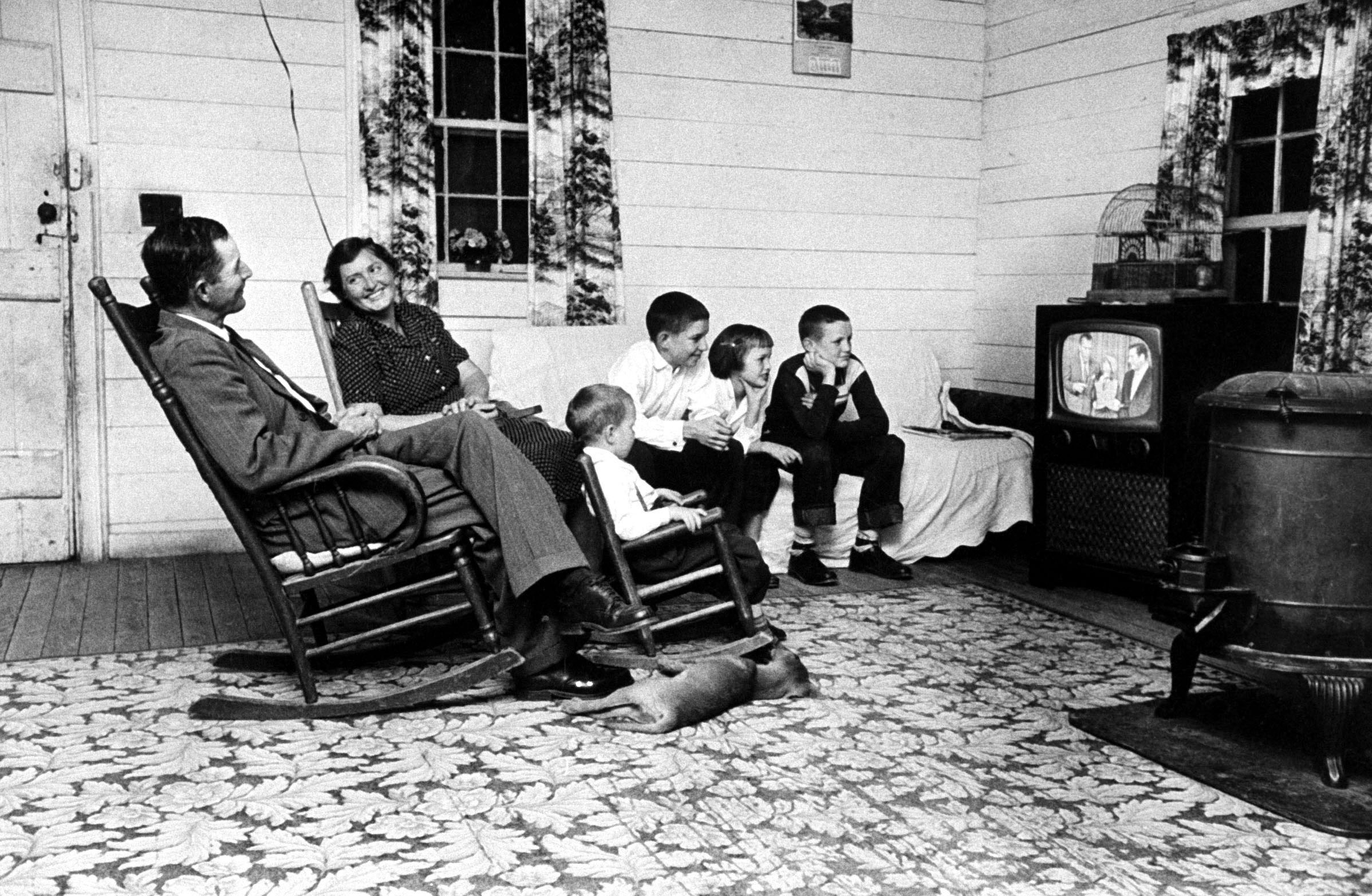 Tenant farmer Thomas B. Knox and his family watch Ed Sullivan and ventriloquist Rickie Layne on The Ed Sullivan Show in 1958.