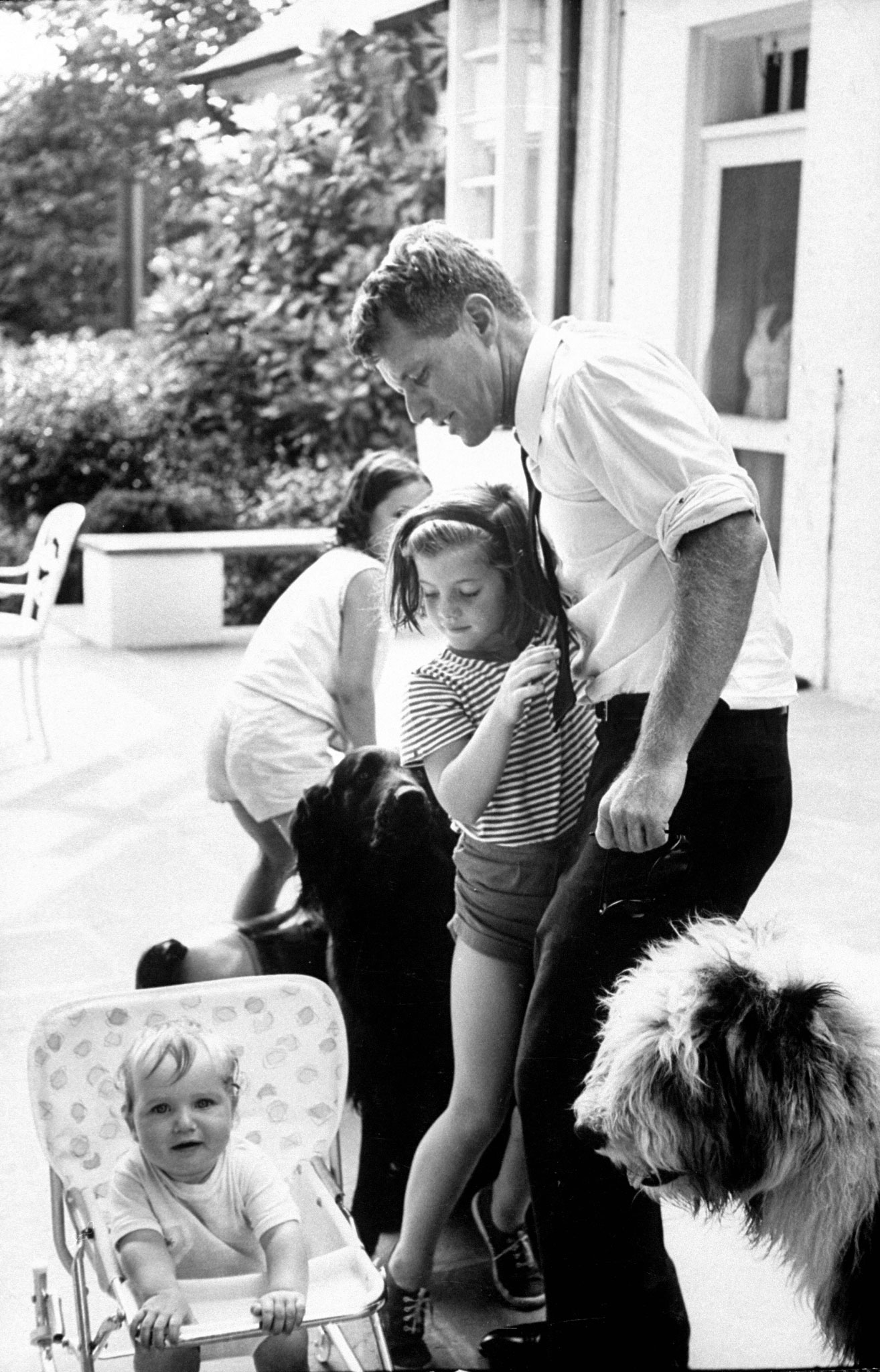 Robert Kennedy with his niece, Caroline; his son, Christopher (in pram); and his daughter, Courtney, 1964.