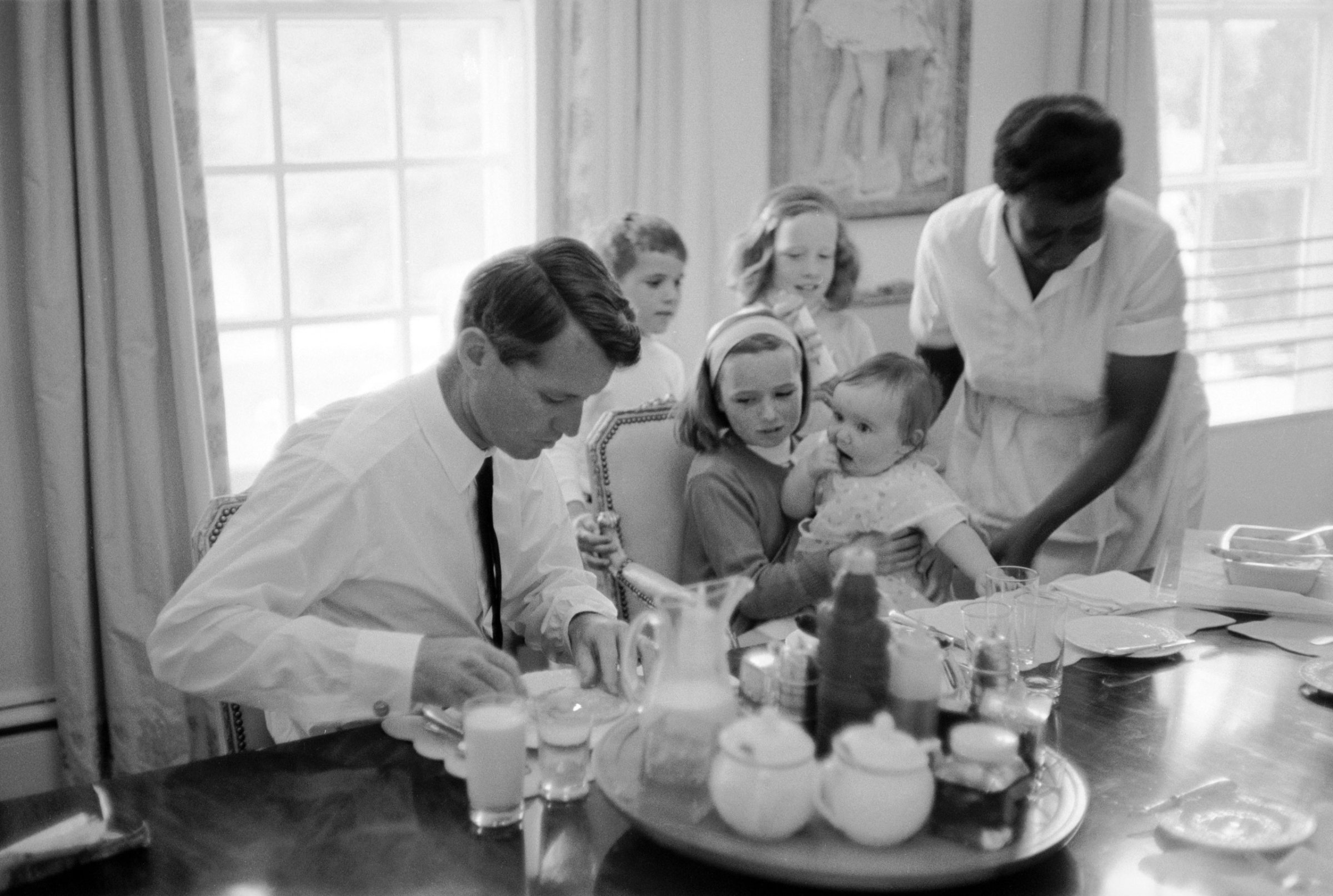 Robert F. Kennedy eats breakfast with his family, 1964.