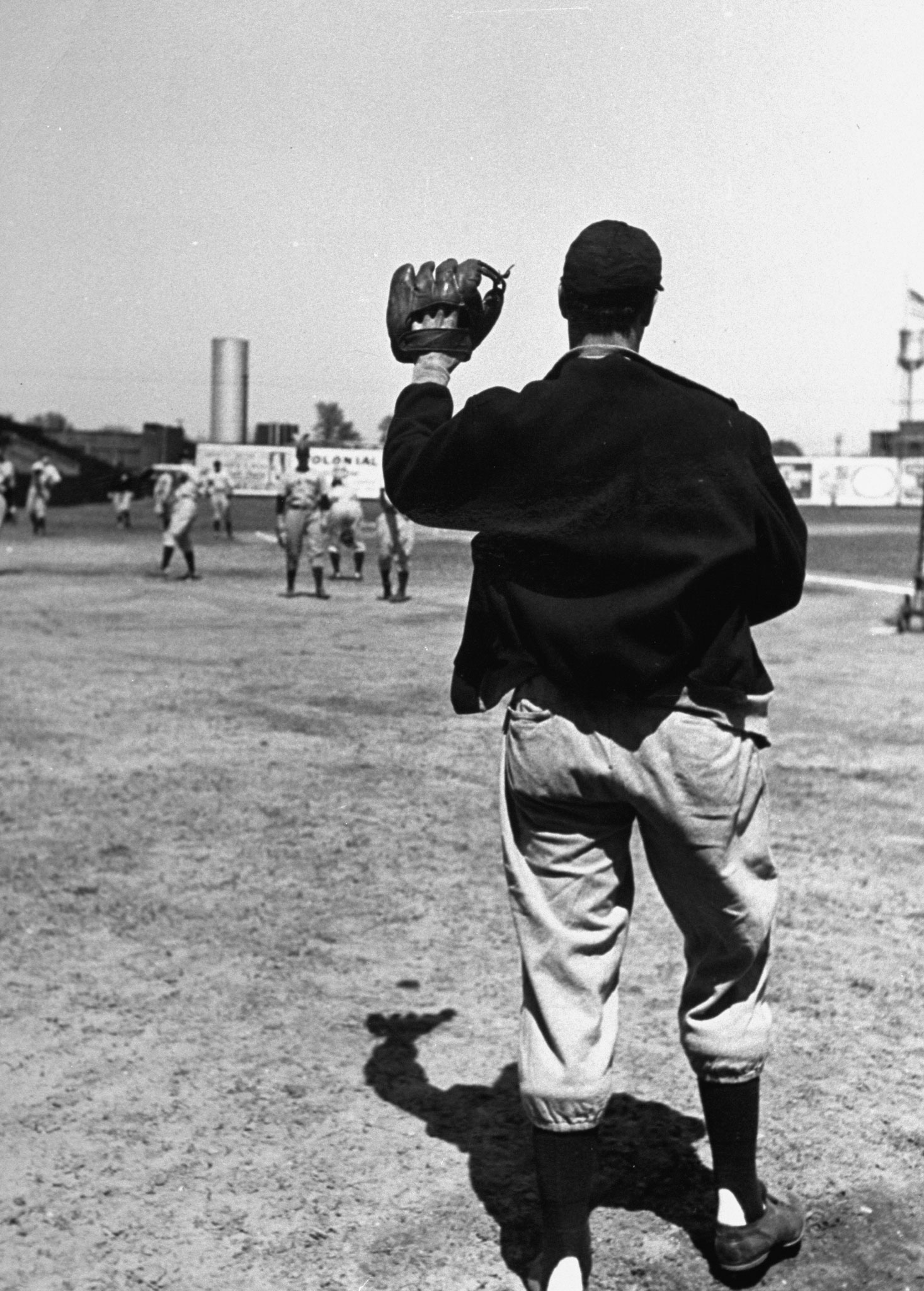 Joe DiMaggio playing catch during warm-up before game vs. the Dodgers, 1939.