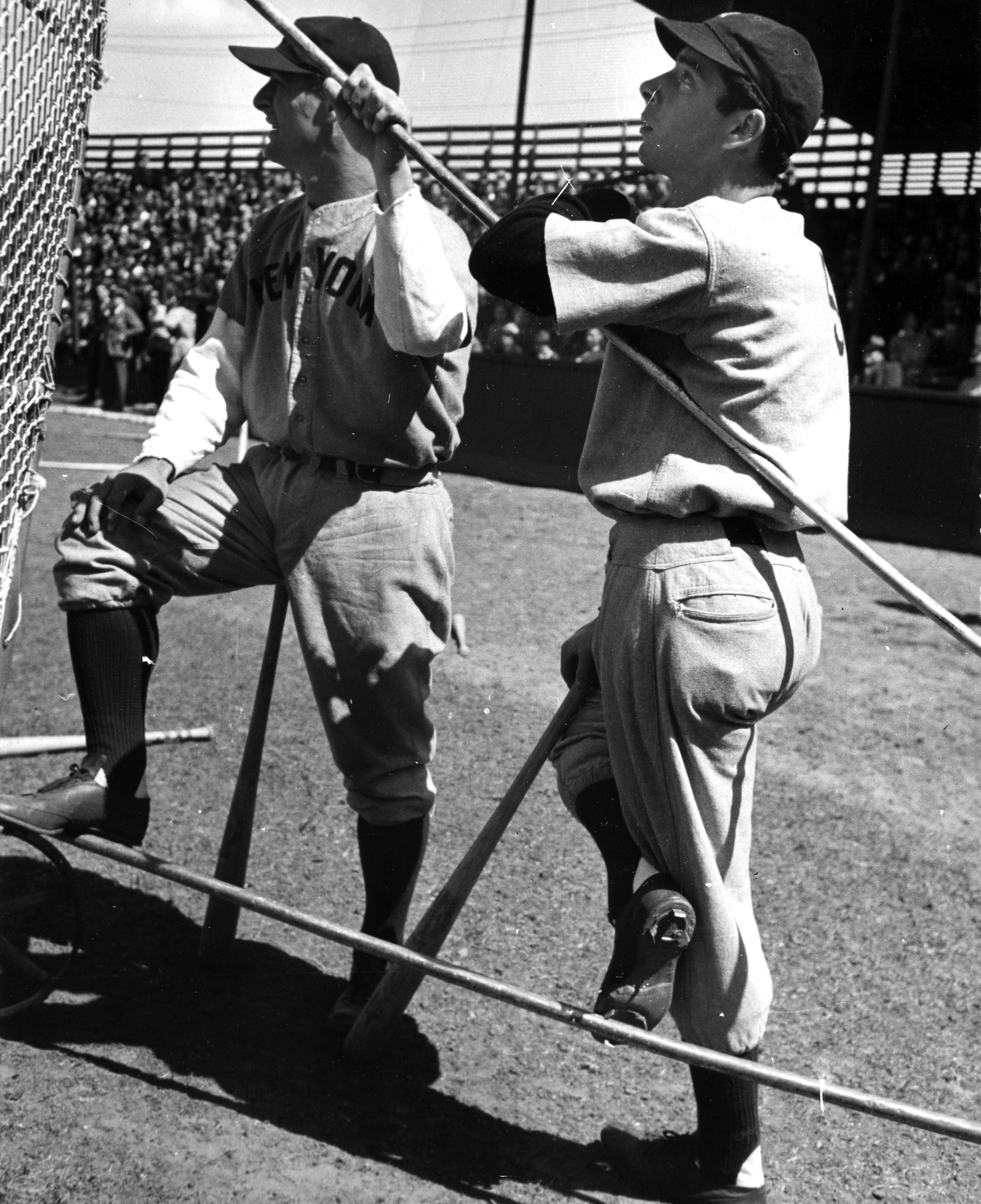 Yankee legends Lou Gehrig and Joe DiMaggio watch batting practice, 1939.