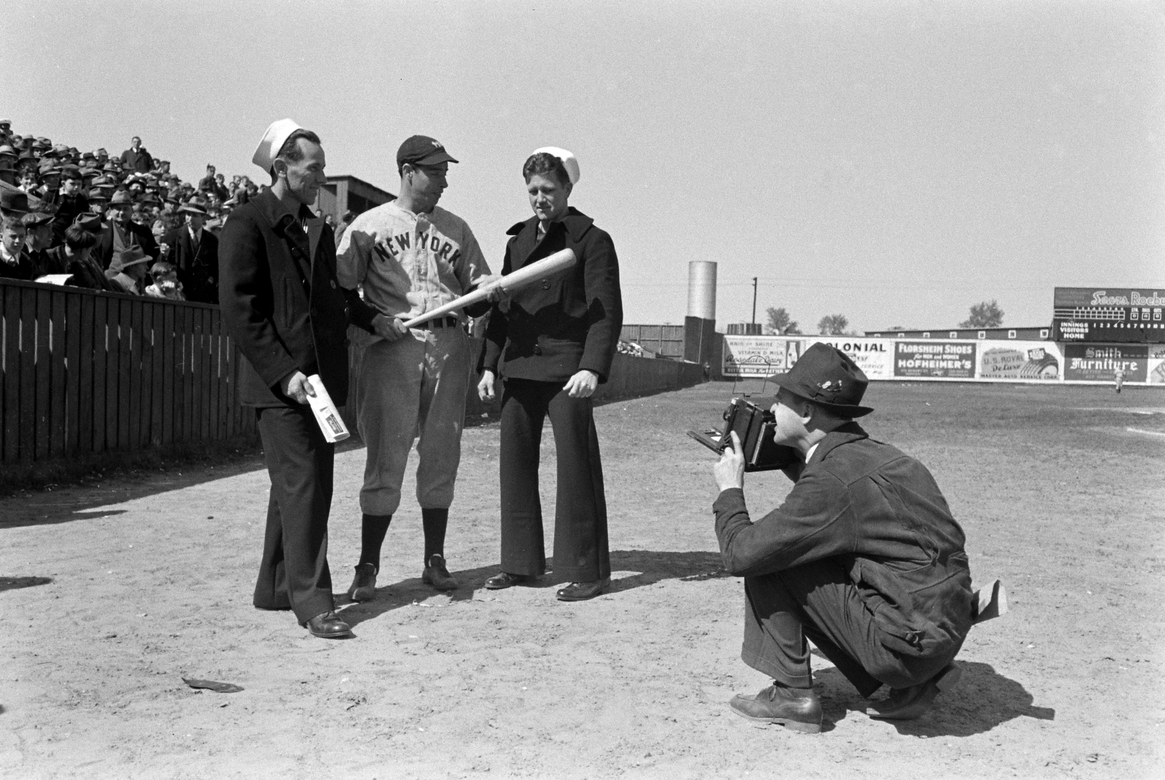Joe DiMaggio with sailors, 1939.