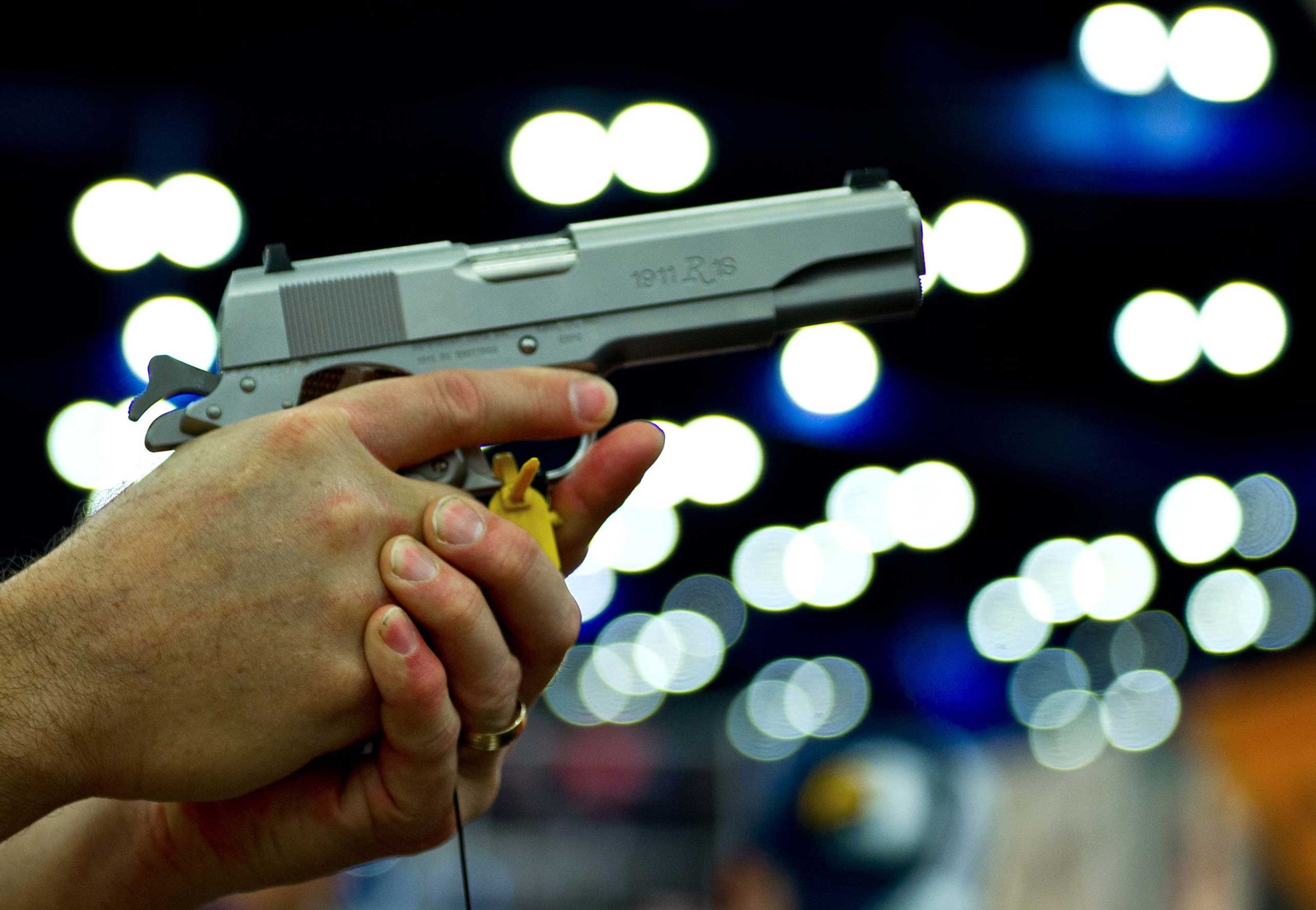 A convention goer handles a Ruger 1911 model semi-automatic pistol during the142nd annual National Rifle Association convention at the George R. Brown Convention Center on May 4, 2013 in Houston.