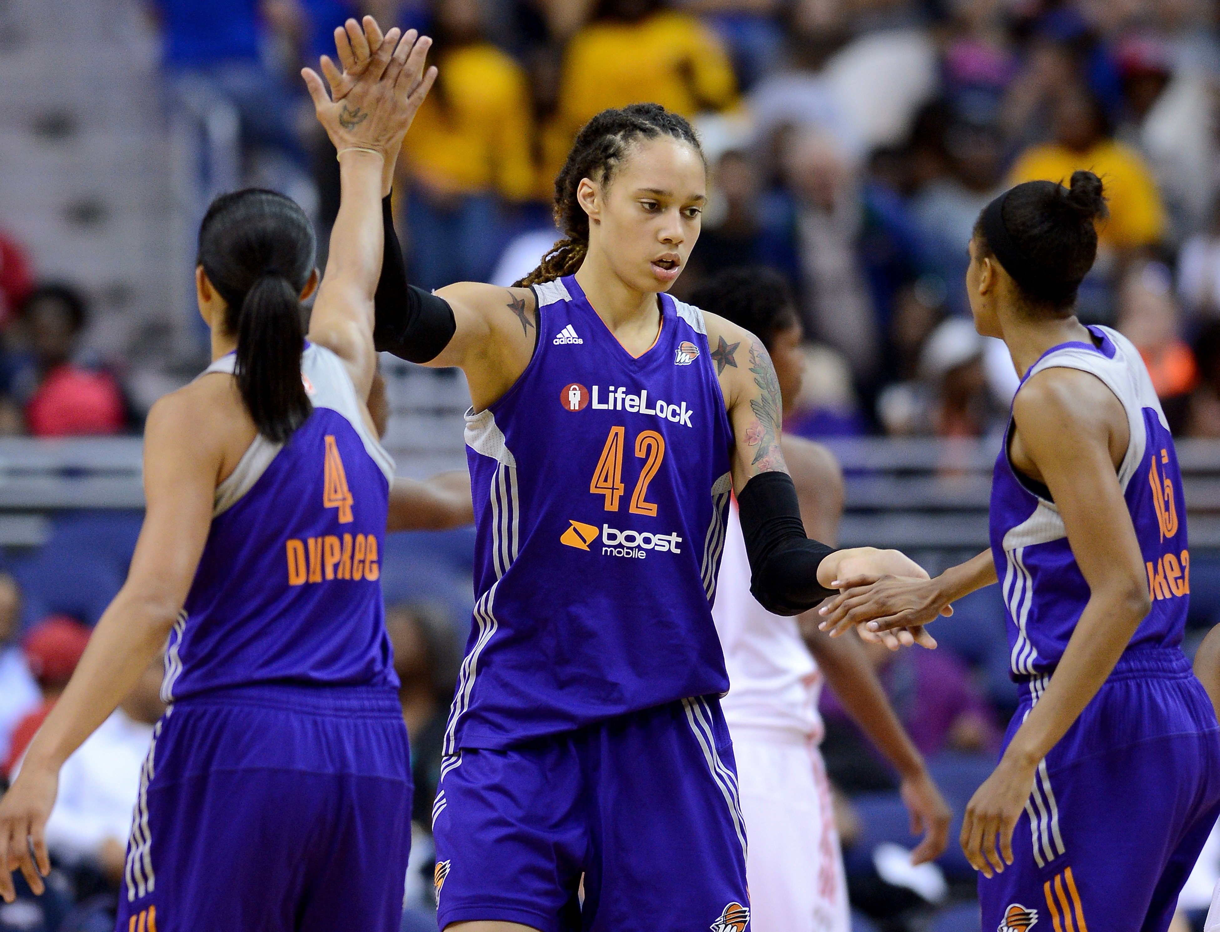 Phoenix Mercury Brittney Griner center (42) celebrates with teammates Candice Dupree (4) and Briana Gilbreath (15), after she scored and drew a foul against the Washington Mystics in the third quarter at the Verizon Center in Washington, D.C., Thursday, June 27, 2013, (Chuck Myers—MCT/Getty Images)