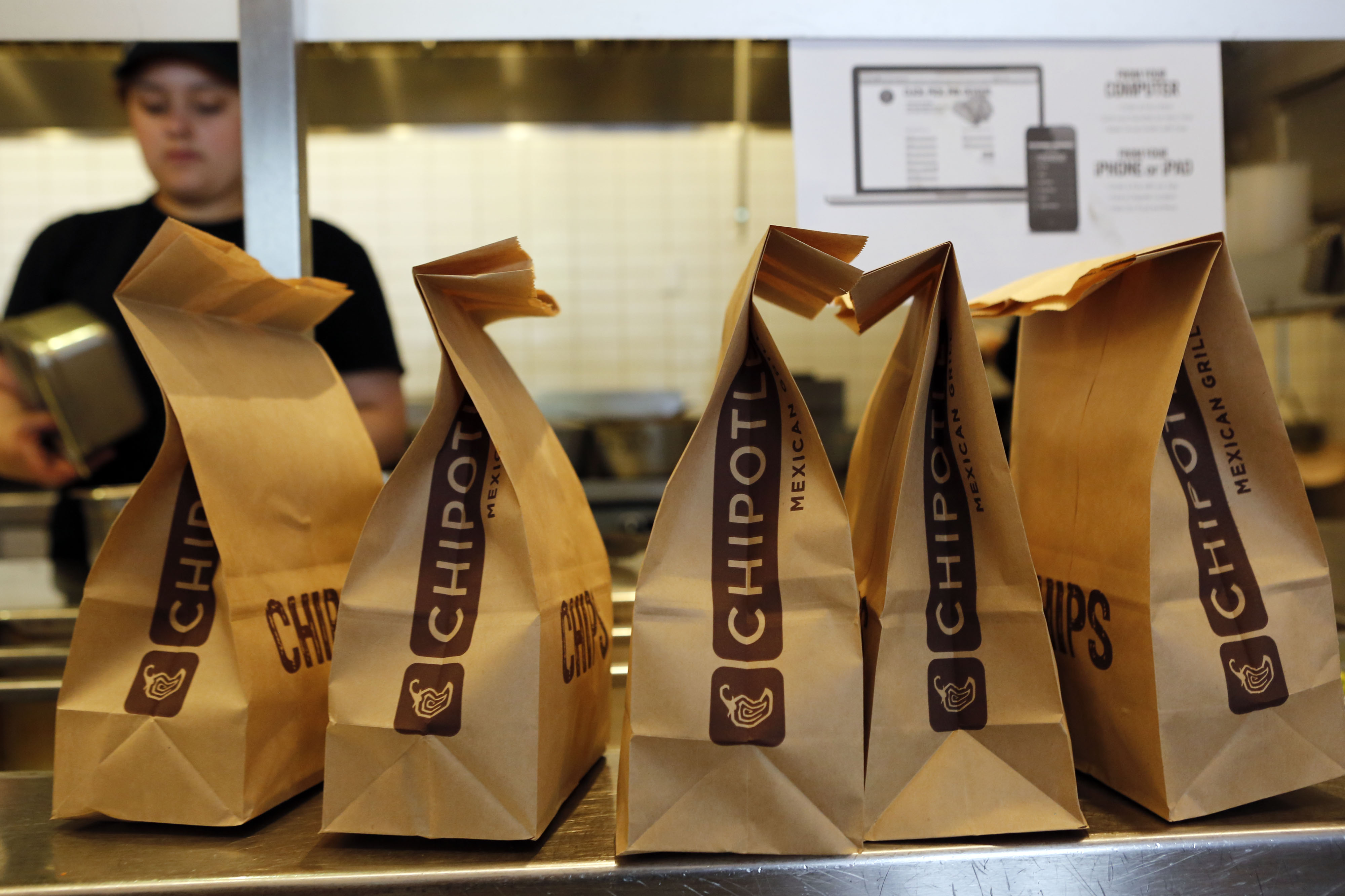 Bags of tortilla chips sit in a row at a Chipotle Mexican Grill Inc. restaurant in Hollywood, California on July 16, 2013.