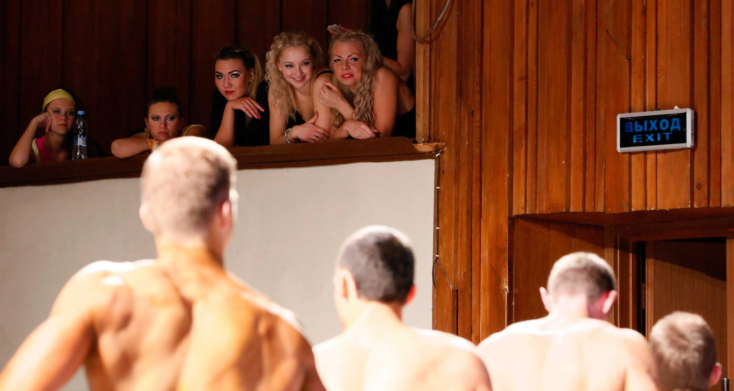 Spectators look at the participants of the "strong body" category competition for beginners during the 5th "Strongo Cup" open amateur bodybuilding tournament in Krasnoyarsk