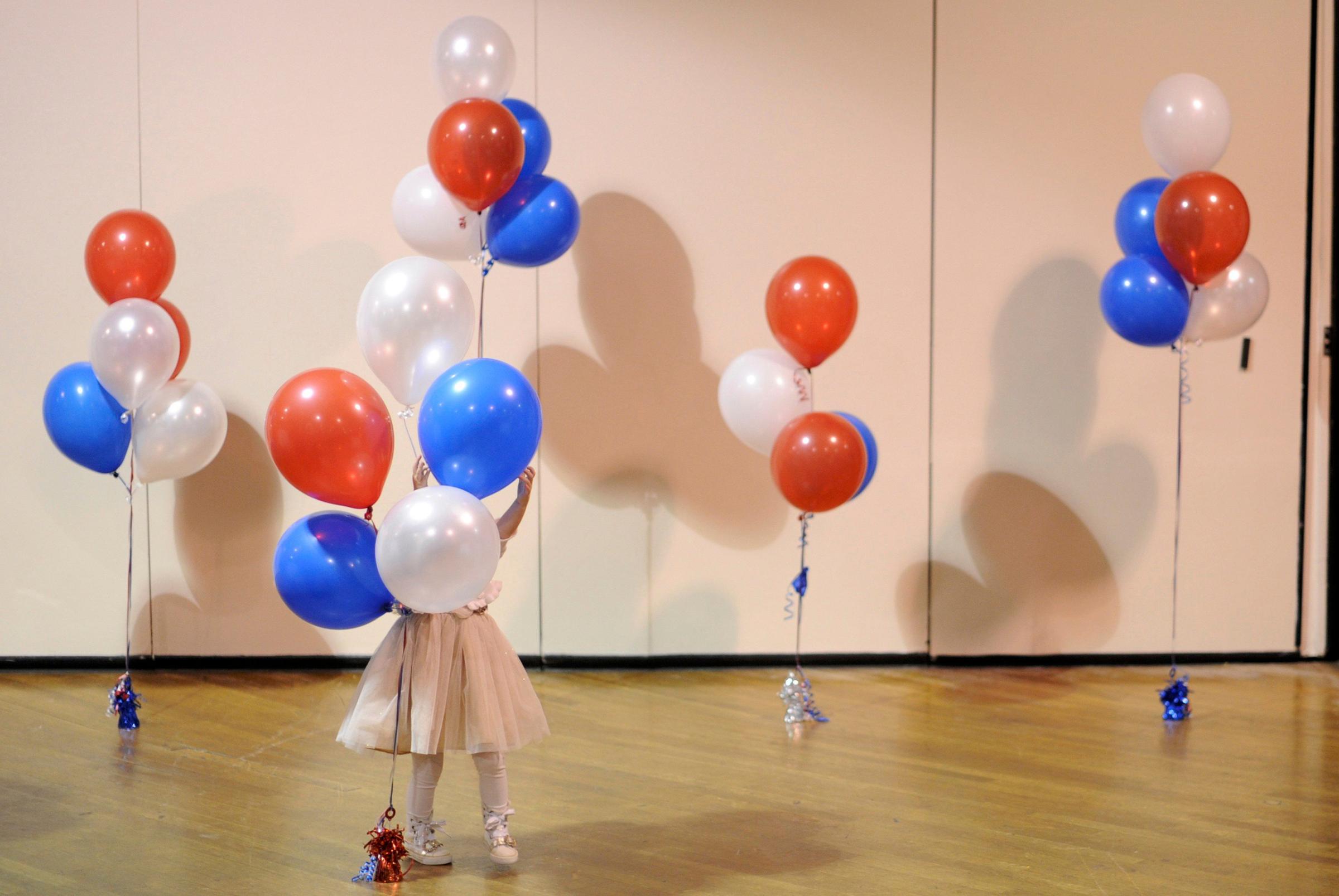 A little girl plays with balloons at Republican U.S. Senate candidate Scott Brown's midterm election night rally in Manchester, New Hampshire on Nov. 4, 2014.