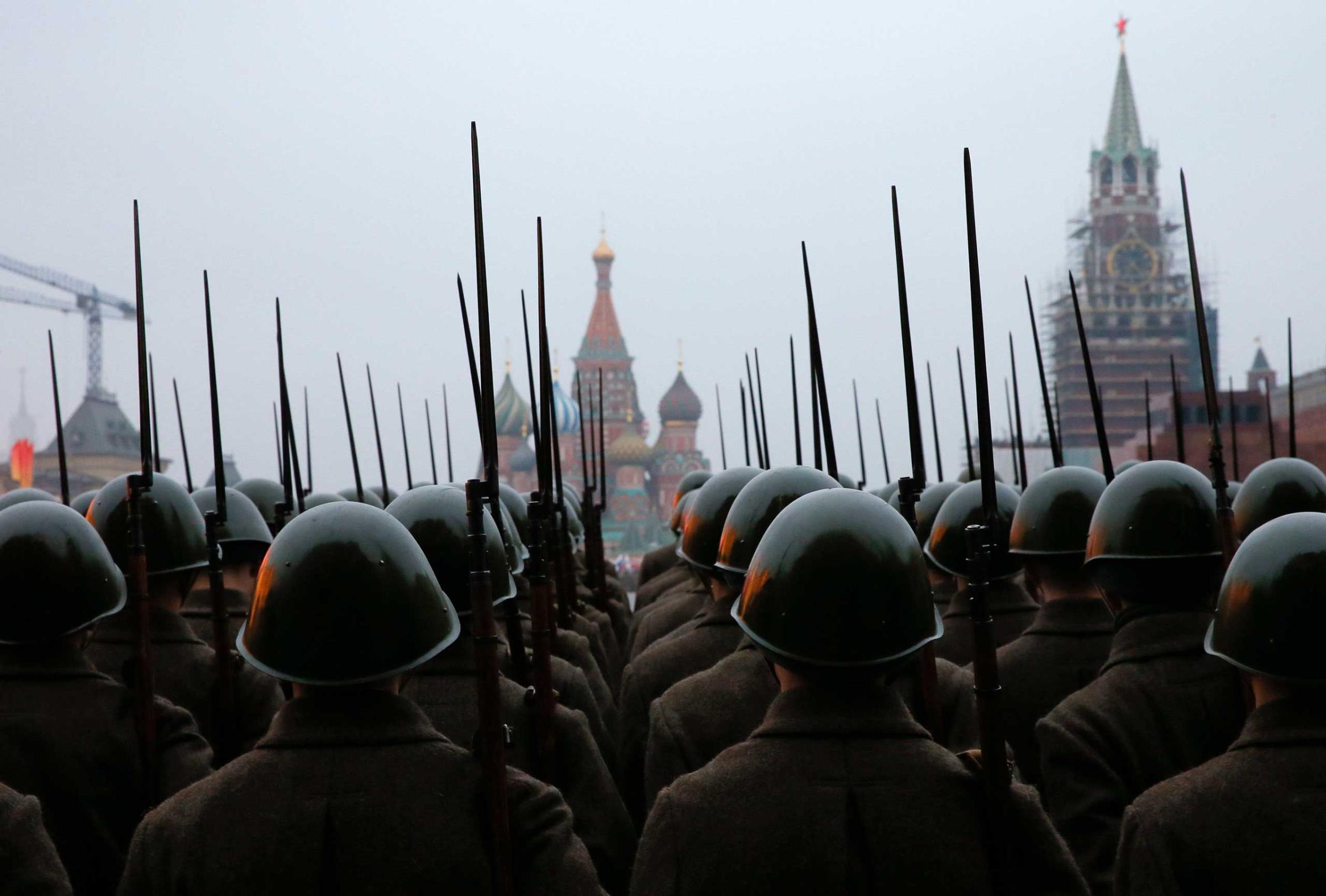 Russian servicemen dressed in historical uniforms take part in a rehearsal for a military parade at the Red Square in Moscow
