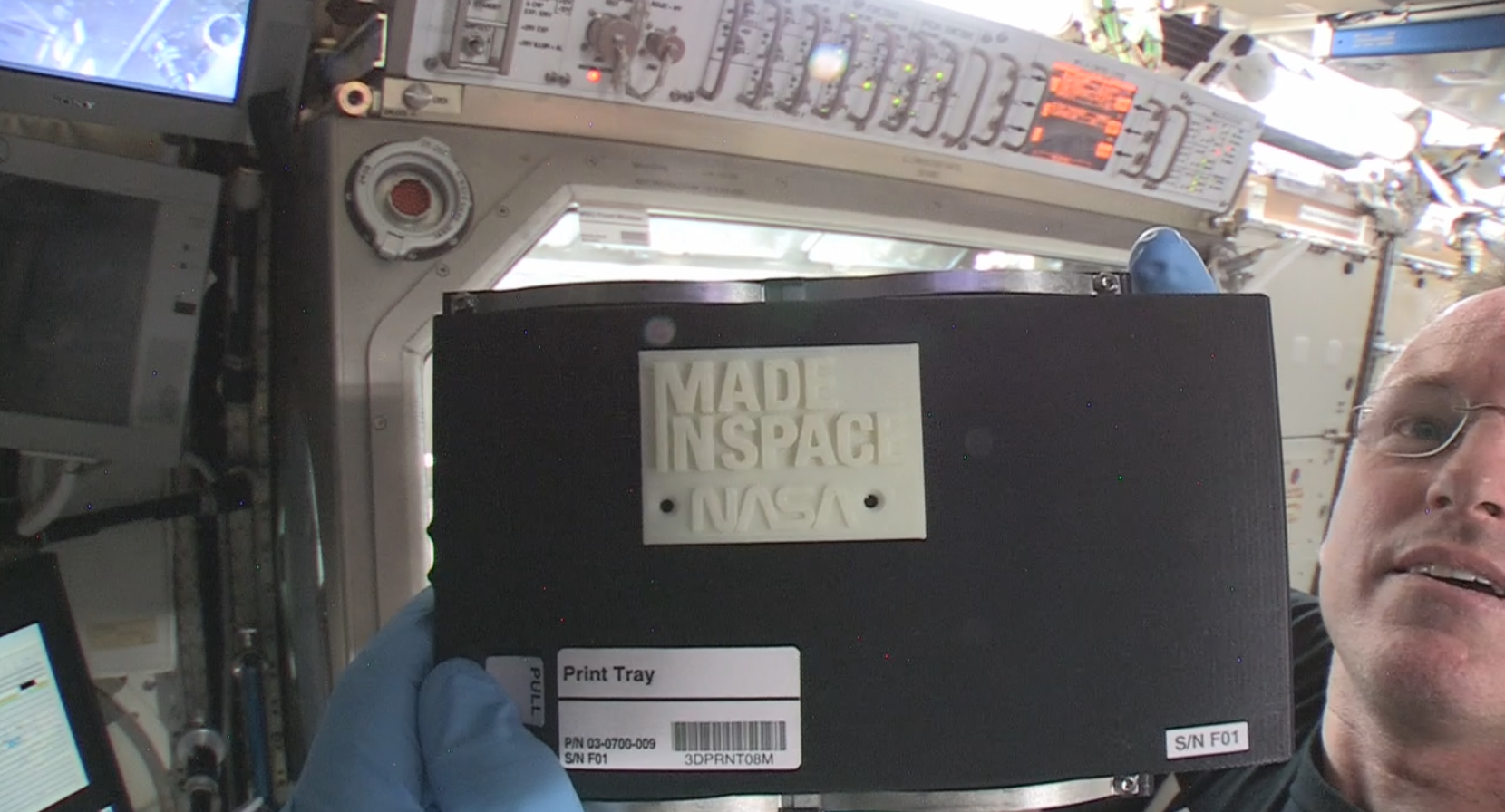 International Space Station Commander Barry “Butch” Wilmore holds up the first object made in space with 3-D printing. Wilmore installed the printer on Nov. 17, 2014, and helped crews on the ground with the first print on Nov. 25, 2014. (NASA)