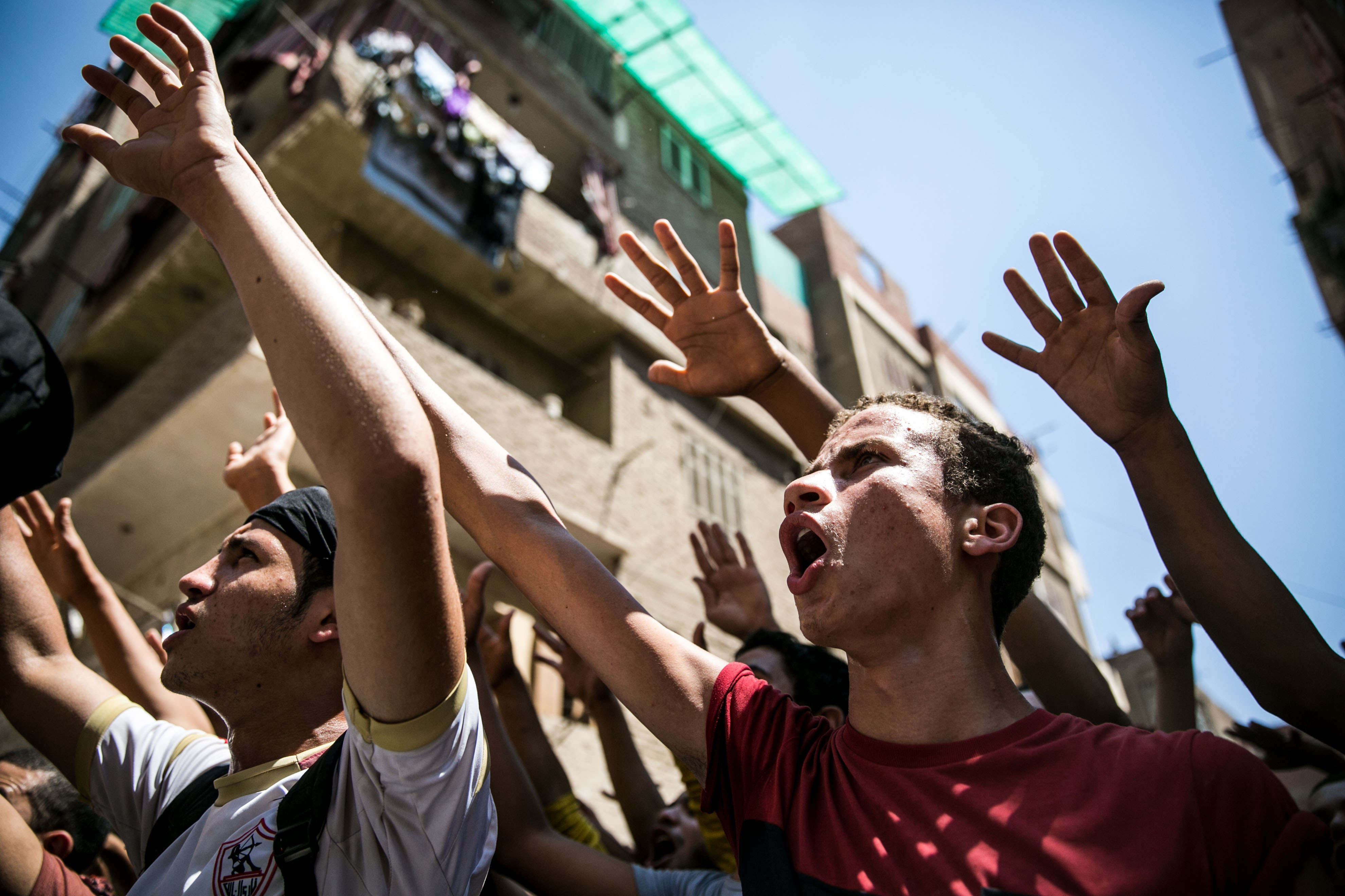Anticoup protesters shout slogans as they march at al-Haram Street during a demonstration on Aug. 14, 2014, in Cairo, marking the first anniversary of the killing of hundreds of Morsi supporters by security forces (Anadolu Agency—Getty Images)