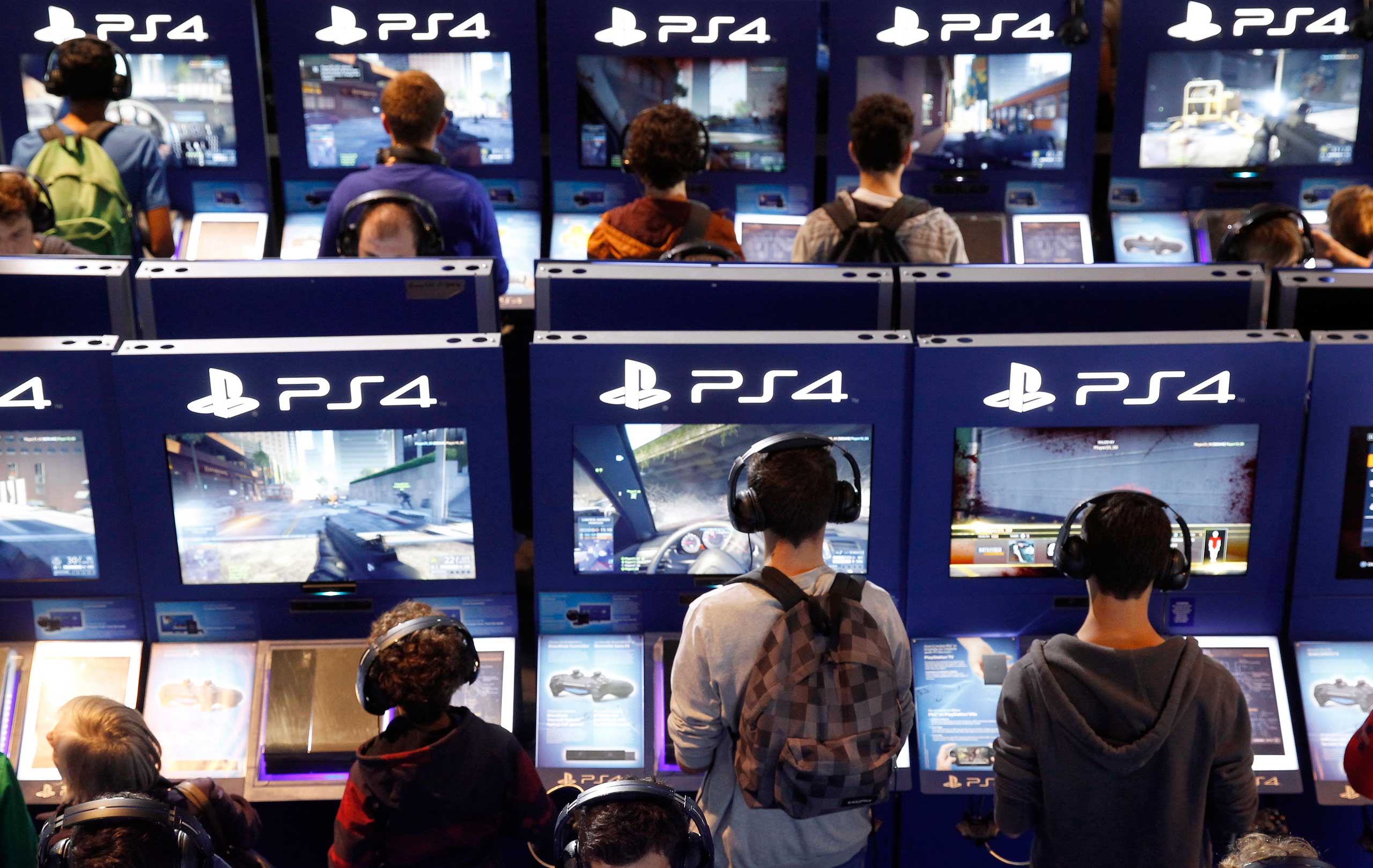 Gamers play video games with the PS4 consoles of PlayStation during the International Games Week on Oct. 29, 2014, in Paris (Chesnot—Getty Images)