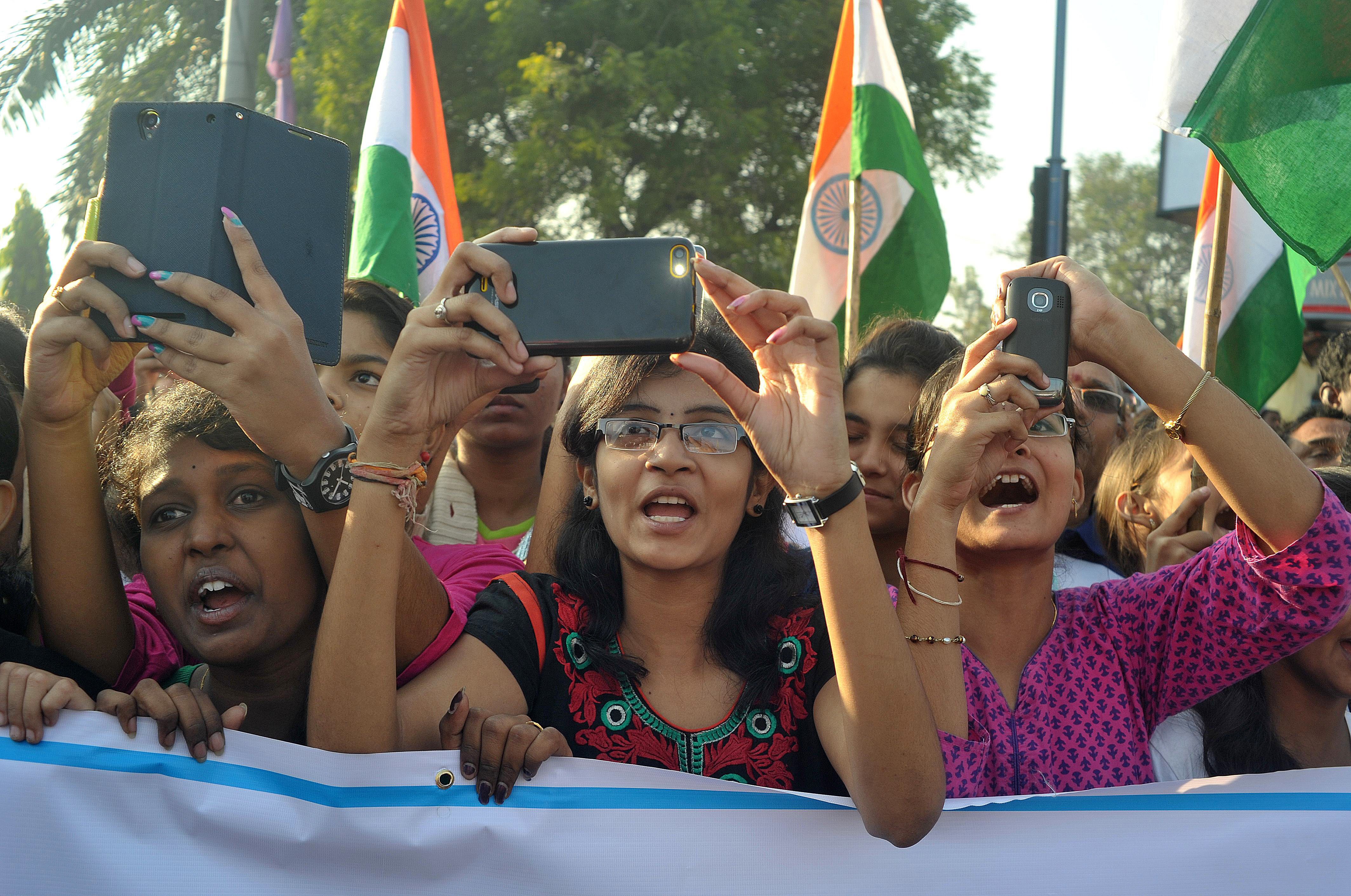Indian students use cellphones to photograph unseen Central Home Minister of India Rajnath Singh during a Run for Unity event to mark the anniversary of the birth of Sardar Vallabhbhai Patel in Hyderabad on October 31, 2014. (Noah Seelam&mdash;AFP/Getty Images)