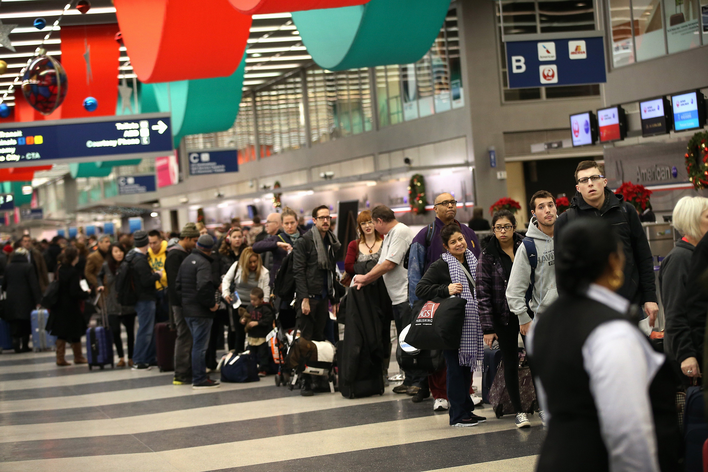 Travelers wait in line to check-in for flights at O'Hare International Airport on December 20, 2013 in Chicago, Illinois. (Scott Olson&mdash;Getty Images)
