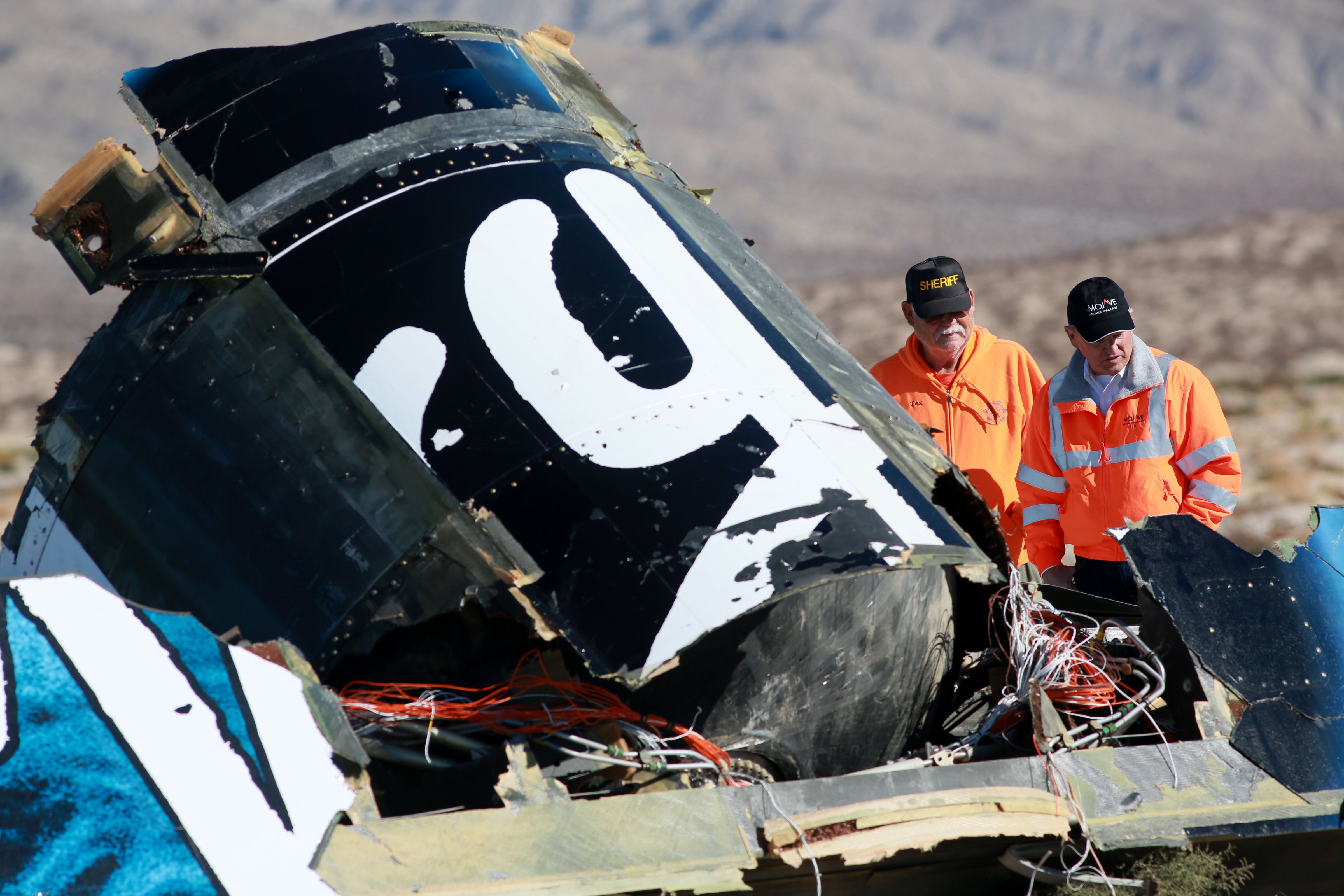 Sheriff's deputies inspect the wreckage of the Virgin Galactic SpaceShip 2 in a desert field November 2, 2014 north of Mojave, California on The Virgin Galactic SpaceShip 2 crashed on October 31, 2014 during a test flight, killing one pilot and seriously injuring another. (Sandy Huffaker&mdash;Getty Images)