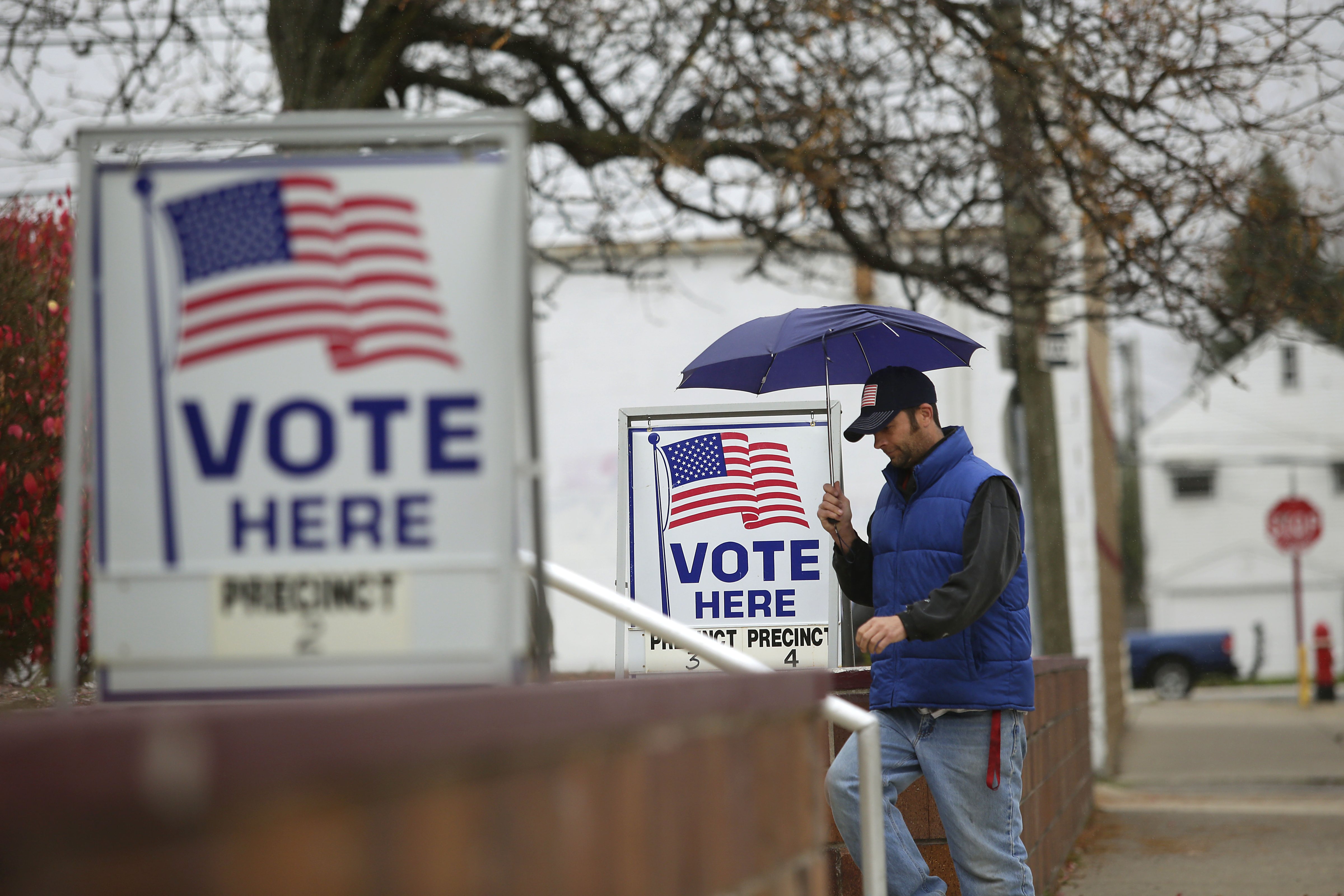 A man fills walks past voting signs displayed outside a polling station during the mid-term elections November 4, 2014 in Hamtramck, Michigan. (Joshua Lott&mdash;Getty Images)