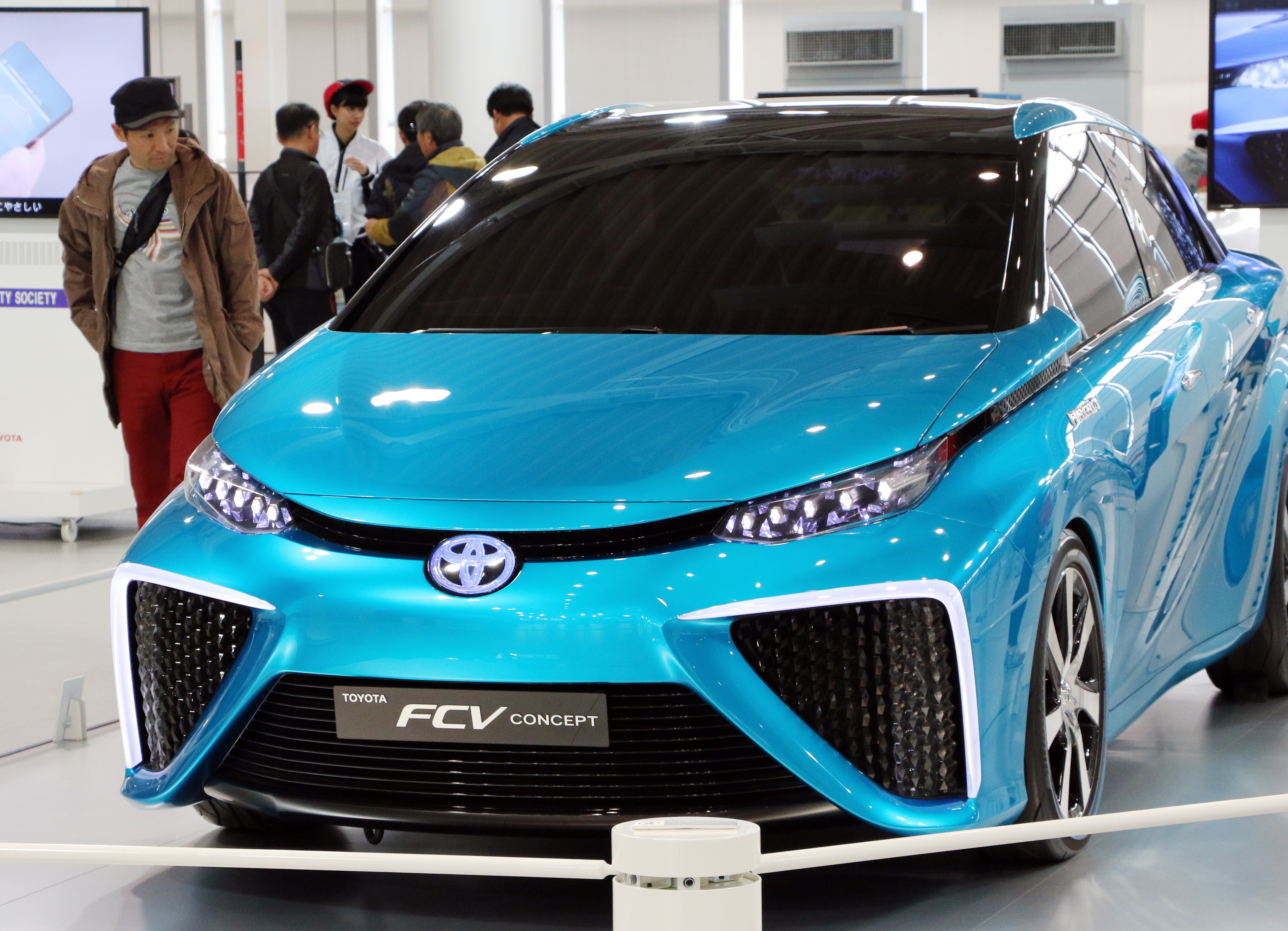 A customer admires Japanese auto giant Toyota Motor's fuel cell vehicle which will go on sale end of this year at Toyota's showroom in Tokyo on November 5, 2014. (Yoshikazu Tsuno—AFP/Getty Images)
