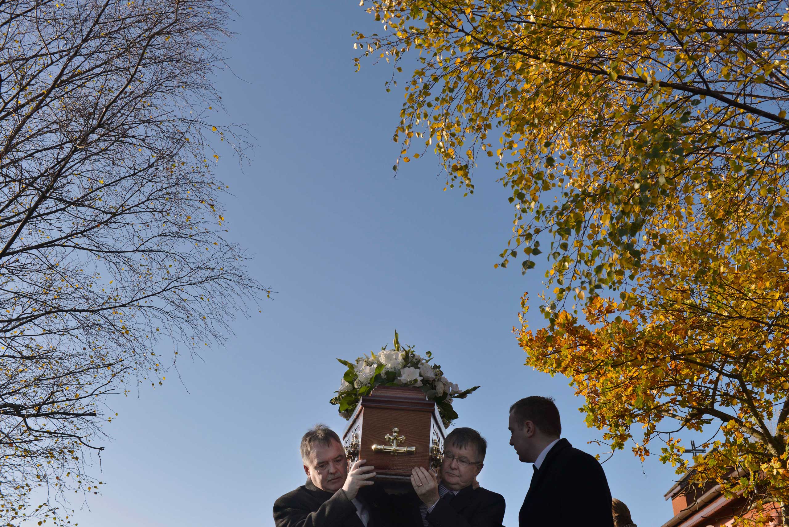 Nov. 14, 2014.  Kieran Megraw (L) and Sean Megraw (R) carry the remains of their brother Brendan as the funeral takes place of Brendan Megraw, known as one of 'the Disappeared' in Belfast, Northern Ireland. Brendan Megraw was taken from his home on the Twinbrook estate in west Belfast in 1978. It was believed that he had been abducted, shot dead and then secretly buried by the IRA who claimed he was working as an agent for the security forces.