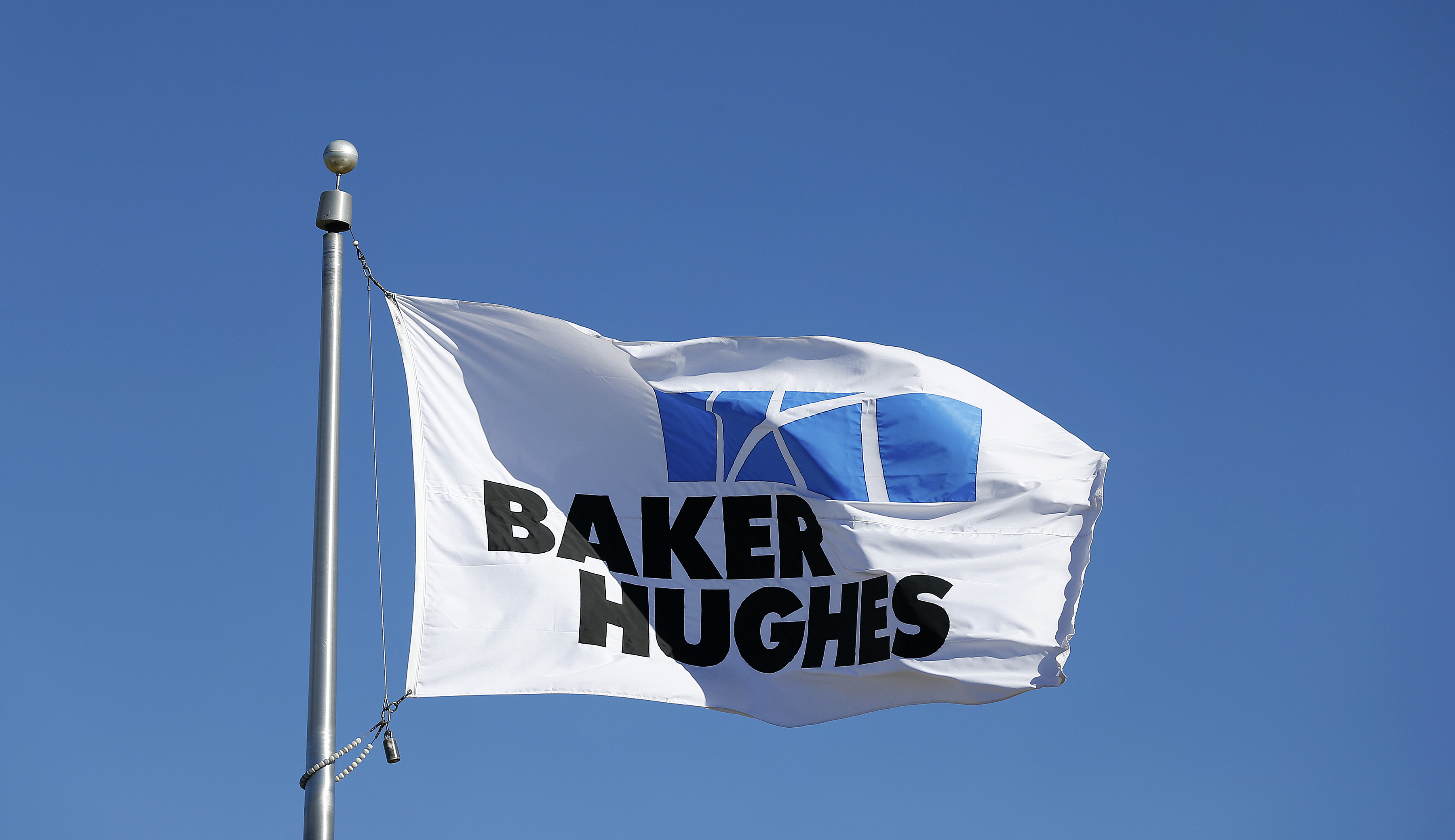 A flag with the Baker Hughes Inc. logo flies outside one of the company's facilities in Houston, Texas, U.S., on Monday, Nov. 17, 2014. (Aaron M—Bloomberg/Getty Images)