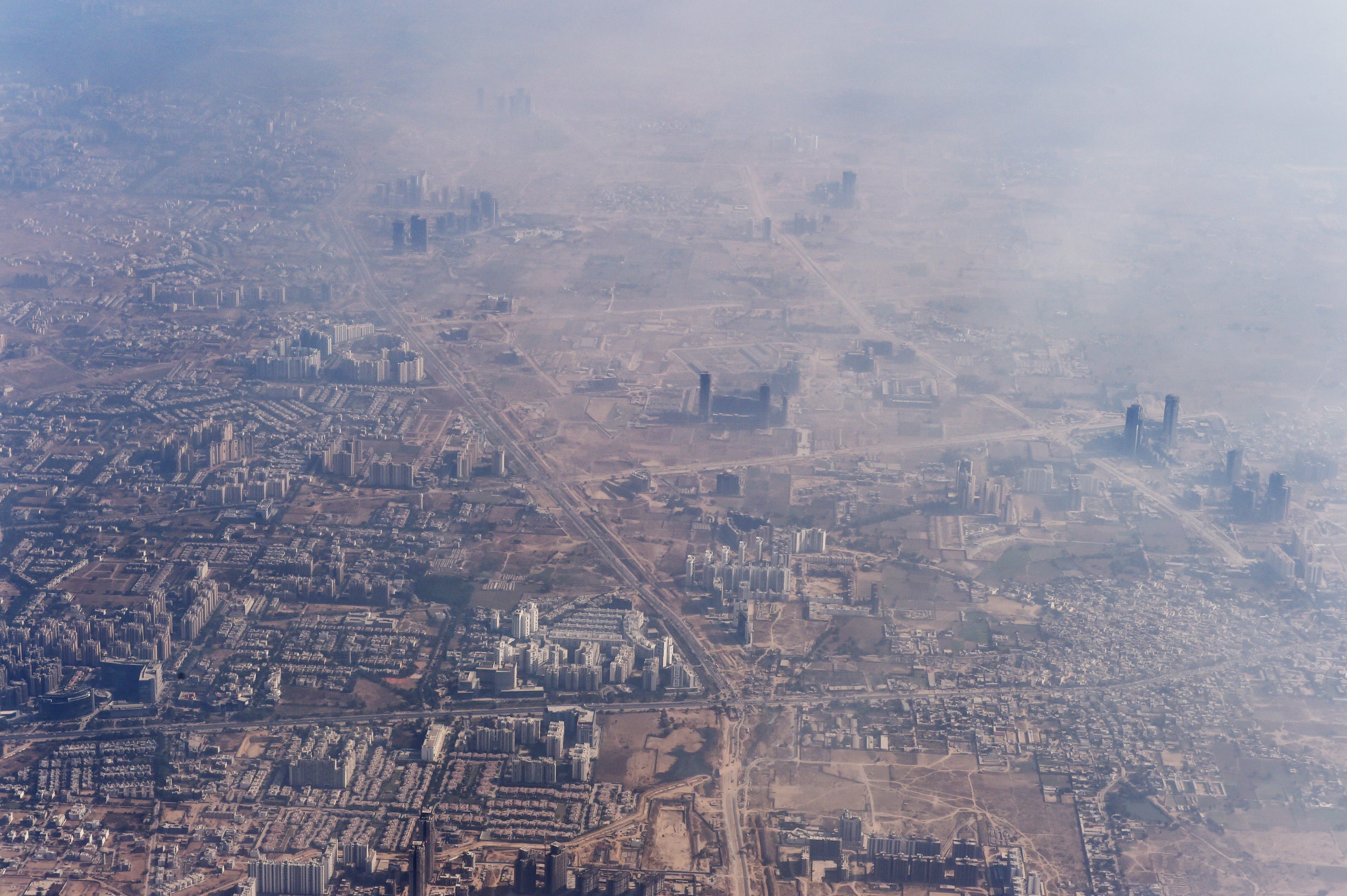 Smog envelops buildings on the outskirts of the Indian capital New Delhi on November 25, 2014. (ROBERTO SCHMIDT—AFP/Getty Images)