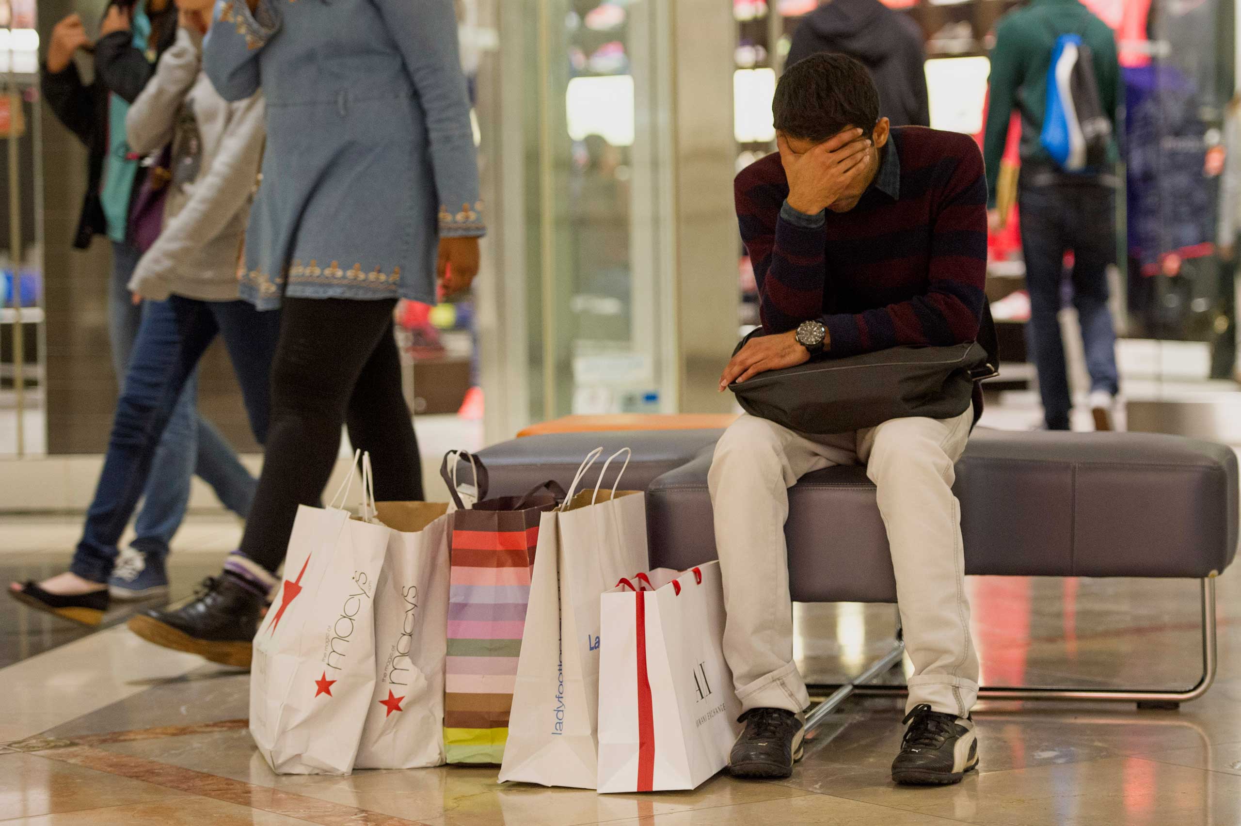 A man takes a break from shopping inside the Westfield San Francisco Centre on Black Friday in San Francisco, Nov. 28, 2014. (David Paul Morris—Bloomberg/Getty Images)