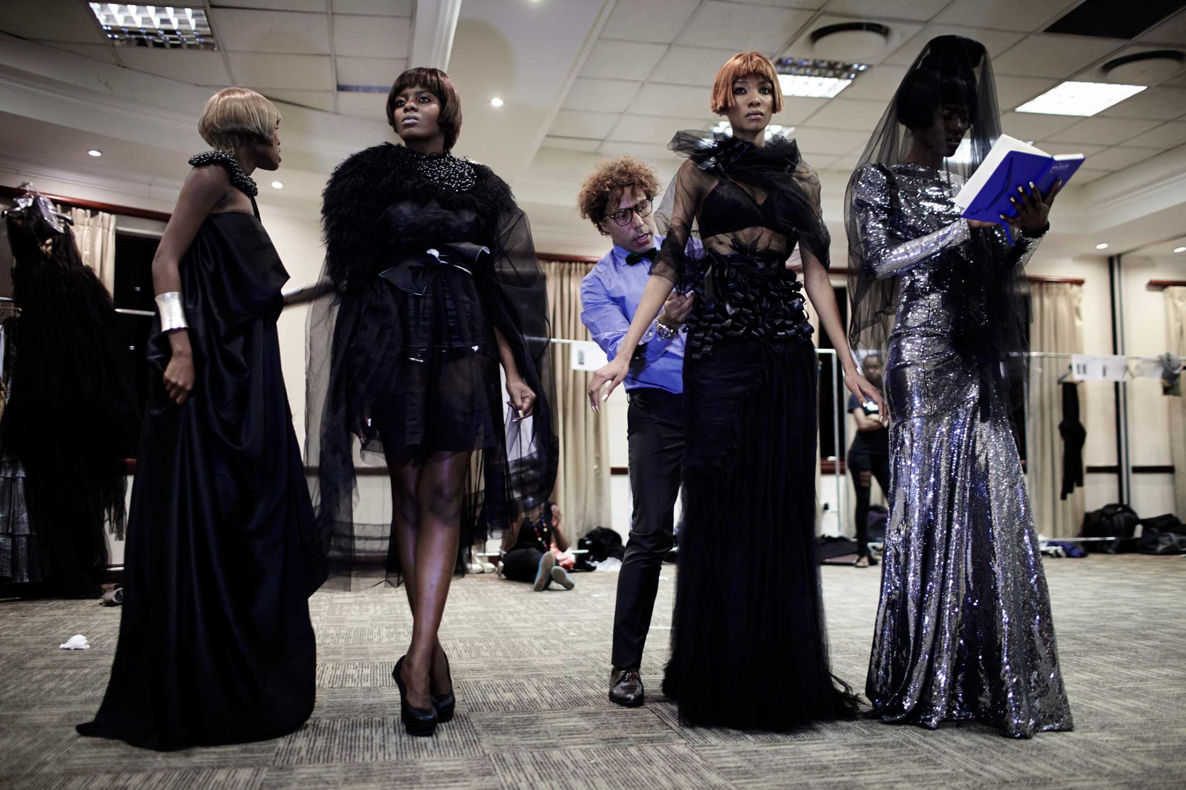Egyptian designer Soucha prepares his models backstage before his fashion show at Color in the Desert Fashion week on Sept. 1, 2012 in Gaborone, Botswana.
