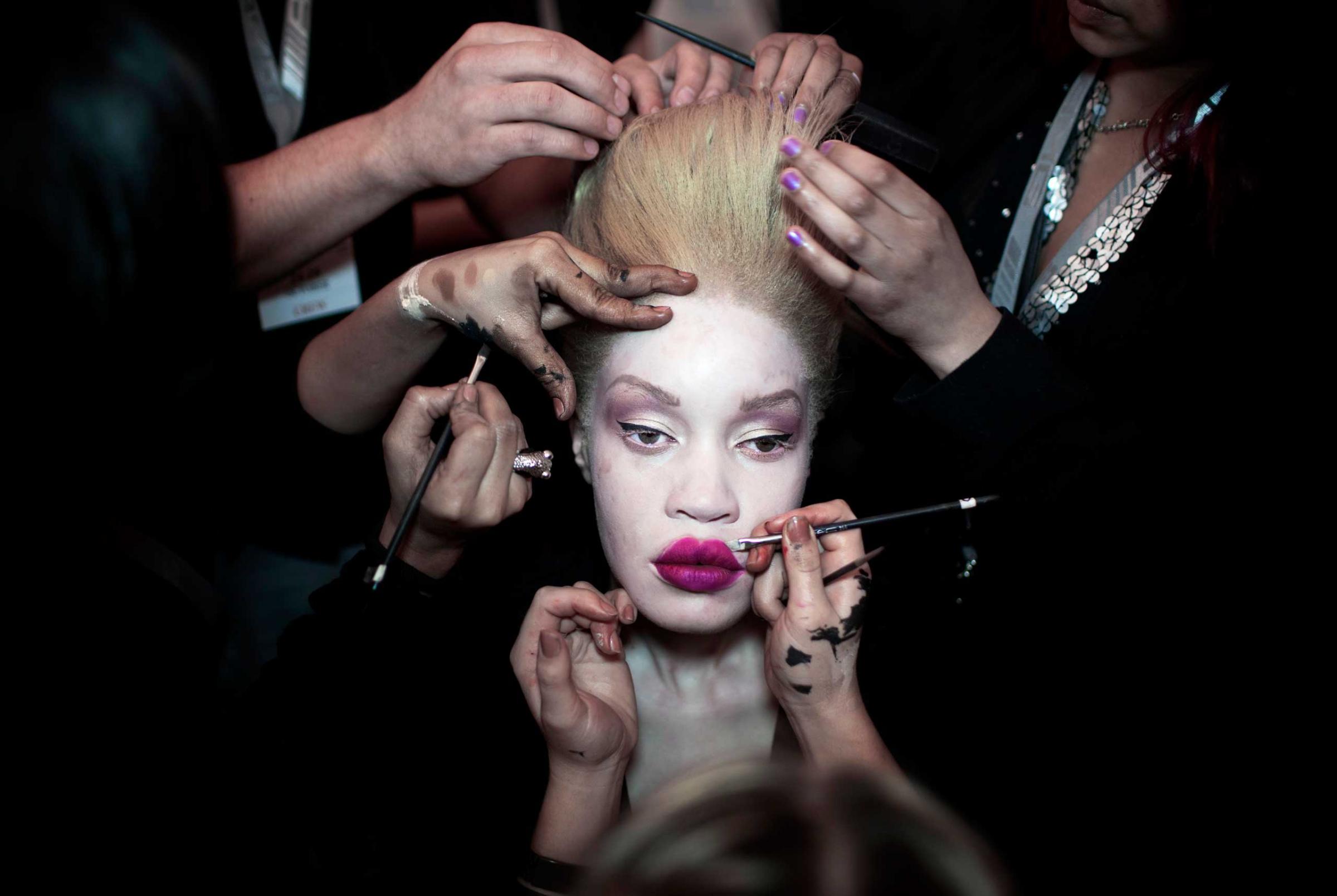 A fashion model has her makeup and hair done backstage before a show at Mercedes Benz Africa fashion week on Oct. 25, 2012 held in Johannesburg, South Africa.