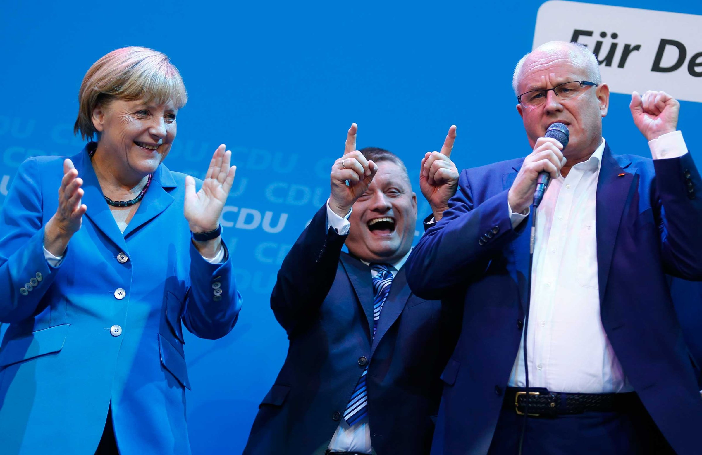 Leaders of the Christian Democratic Union sing with Chancellor Angela Merkel as they celebrate the exit polls in the German general election at the party headquarters in Berlin, Sept. 22, 2013.