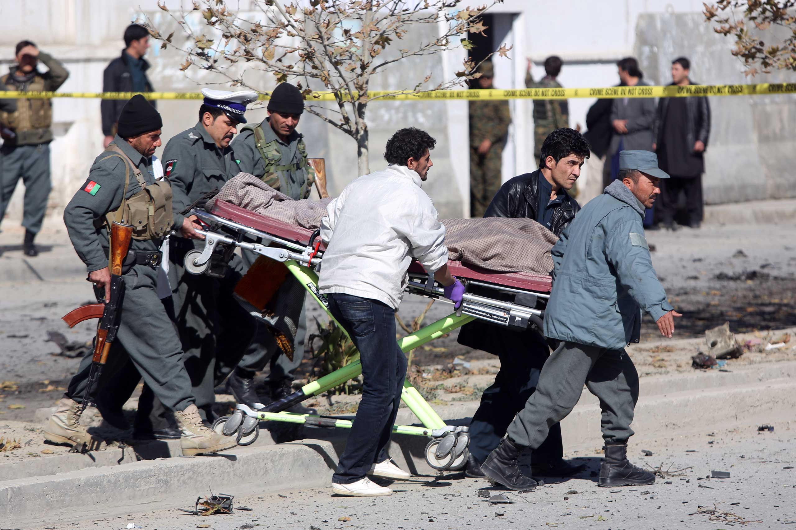 Afghan security forces carry the body of a civilian after a suicide attack in Kabul that targeted Shukria Barazkai, a prominent female member of Afghanistan's parliament, Nov. 16, 2014. (Rahmat Gul—AP)