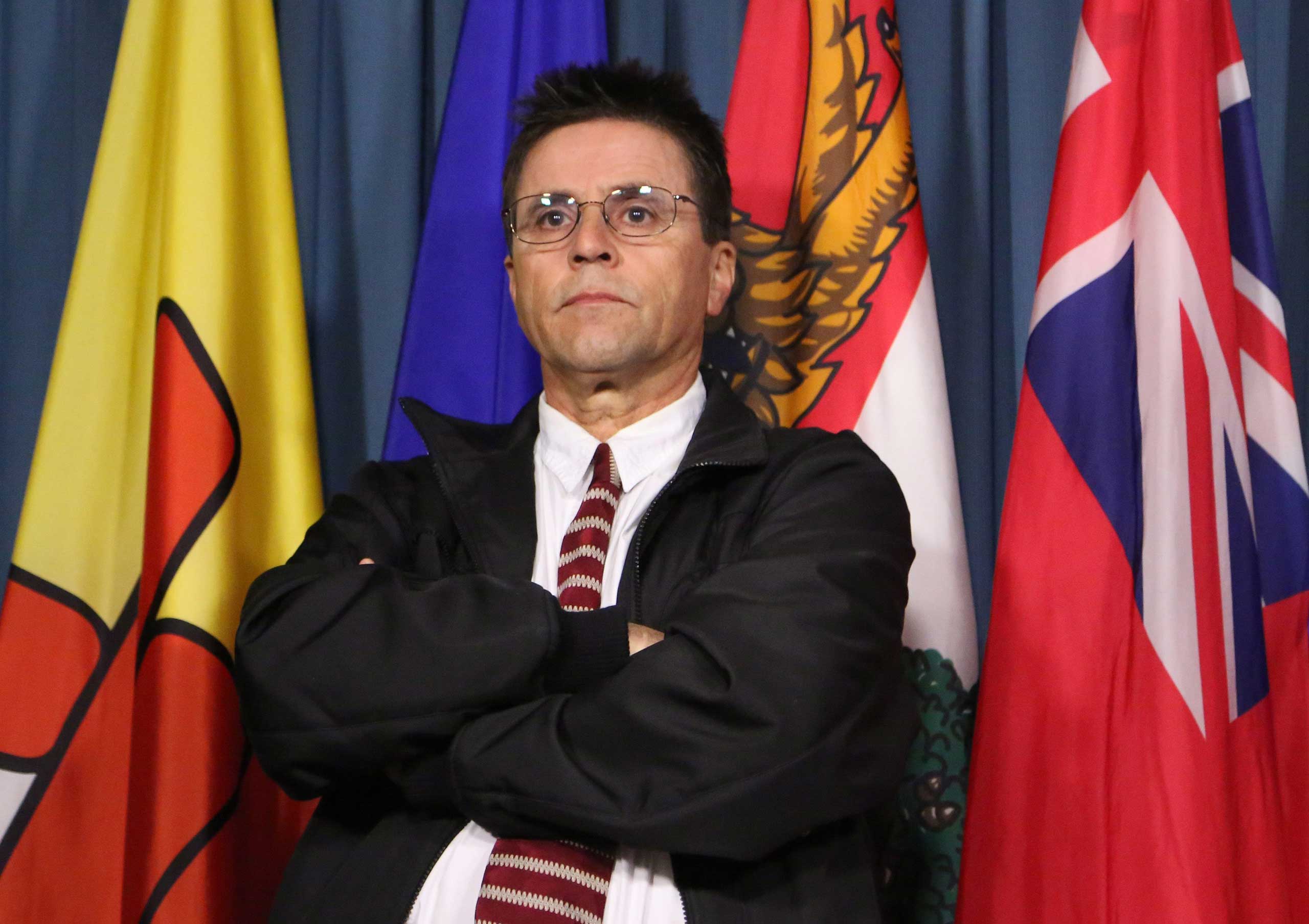 Hassan Diab, the Ottawa professor who has been ordered extradited to France by the Canadian government, listens to his lawyer speak at a press conference on Parliament Hill in Ottawa, April 13, 2012. (Patrick Doyle—AP)