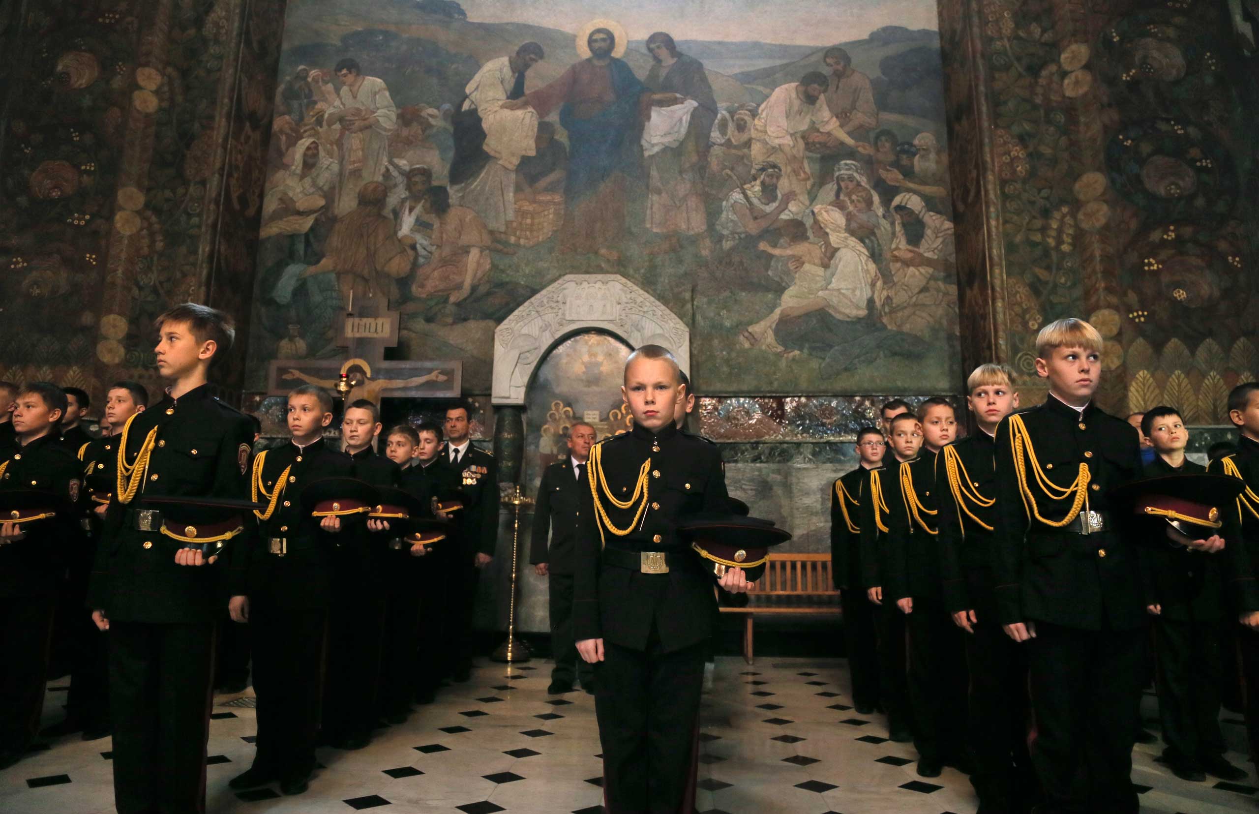 Nov. 14, 2014. Boys from a Ukrainian cadet's lyceum pray during the initiation ceremony in Orthodox Monastery of Caves in Kiev, Ukraine.